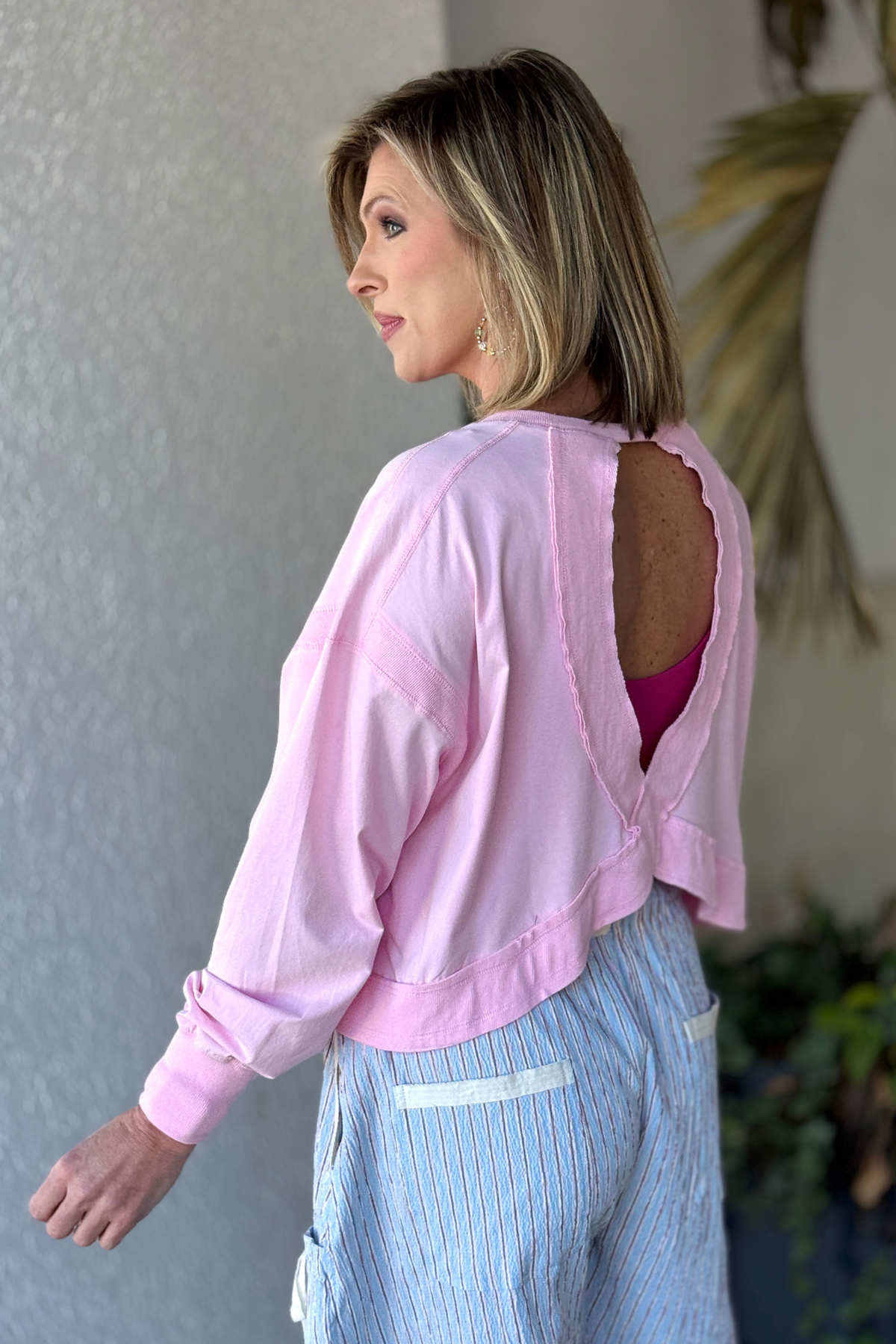 Sweet pink mineral washed open back long sleeve top back view