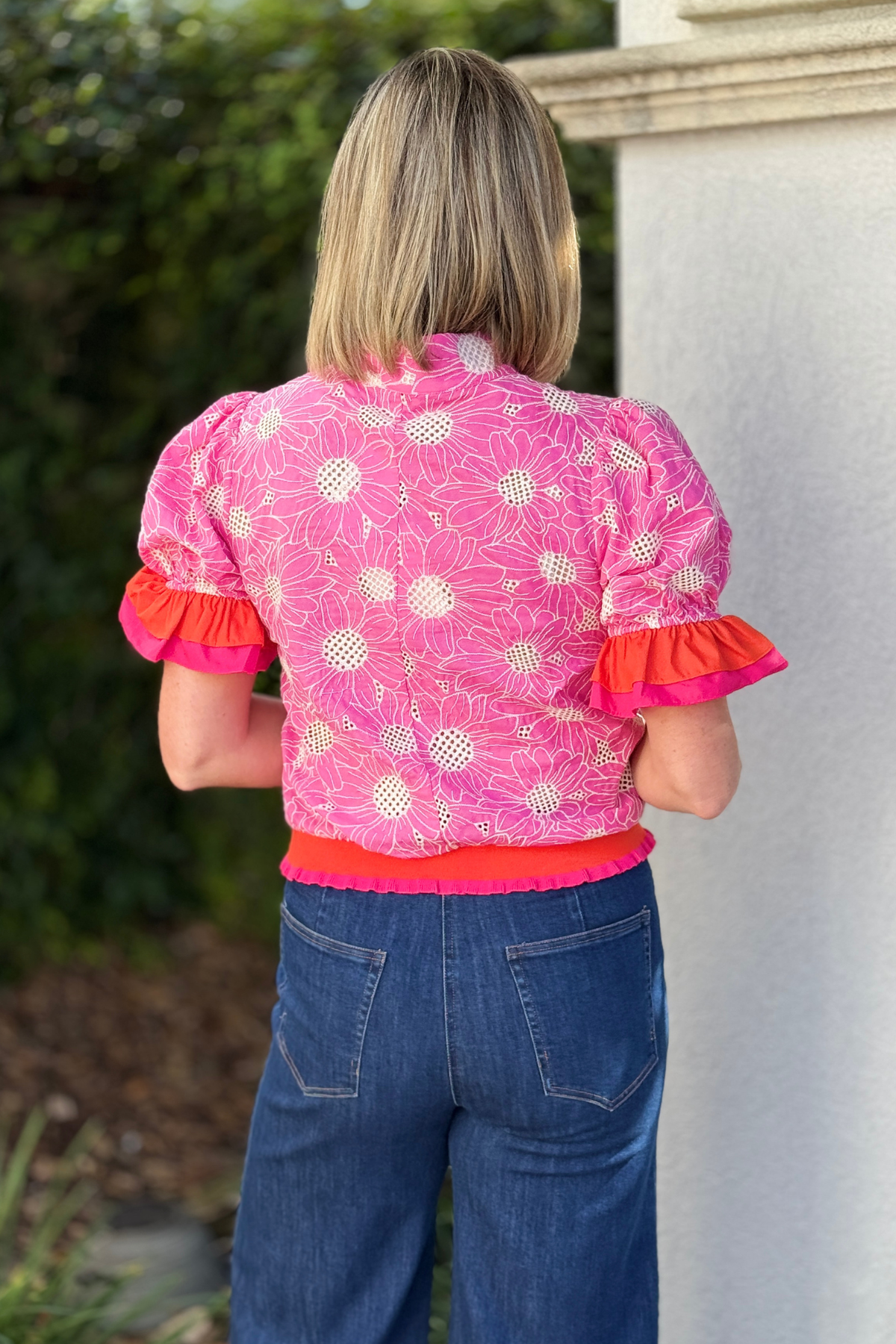 Color block trim floral eyelet top styled with white denim