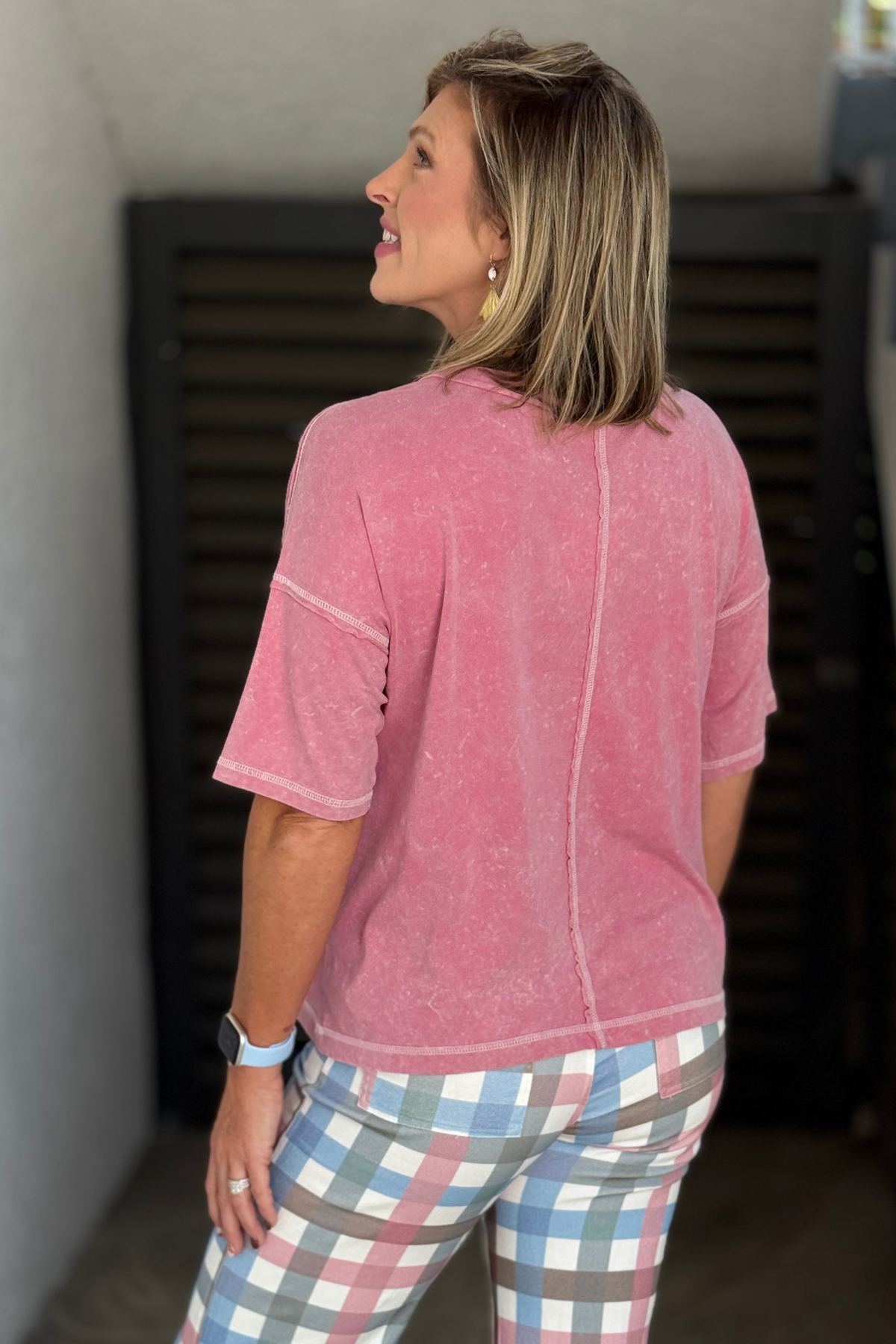 Women’s pink short sleeve Henley top with exposed stitching