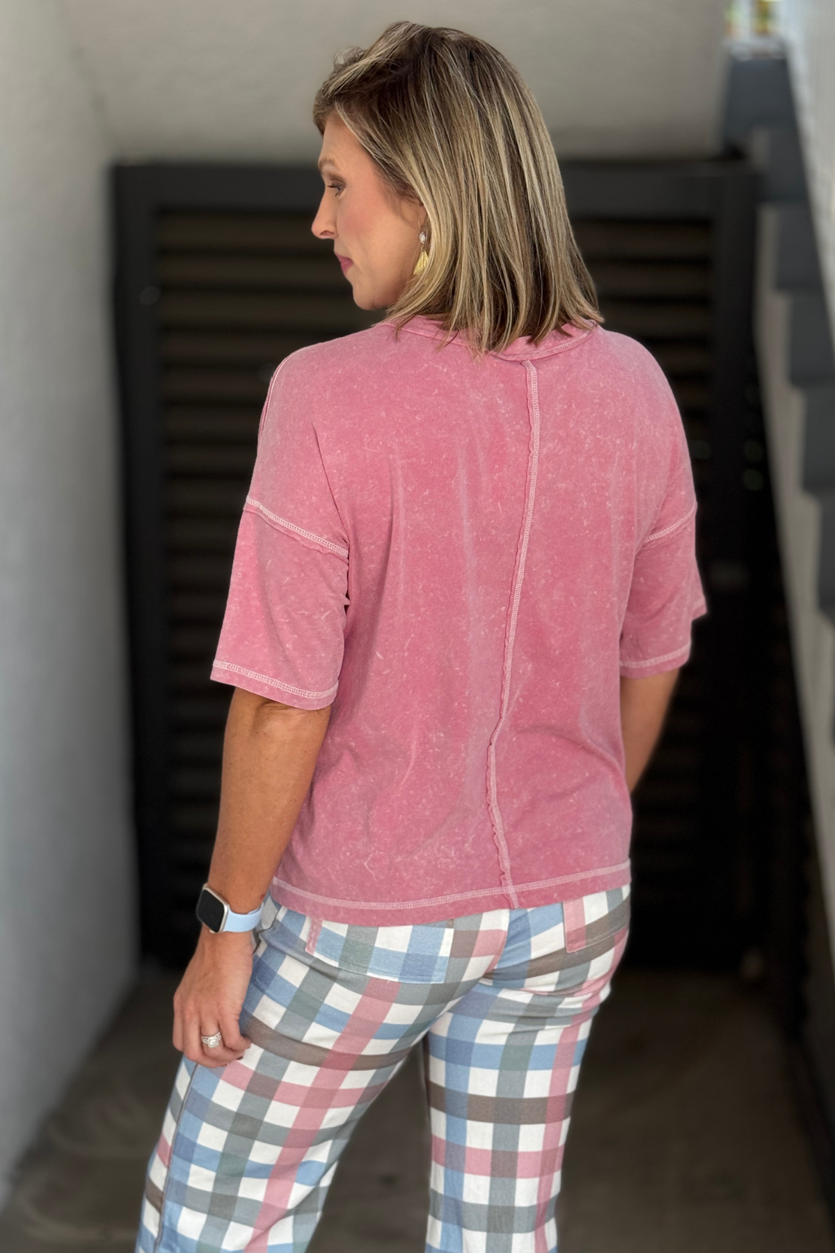Pink mineral wash casual top styled with plaid pants