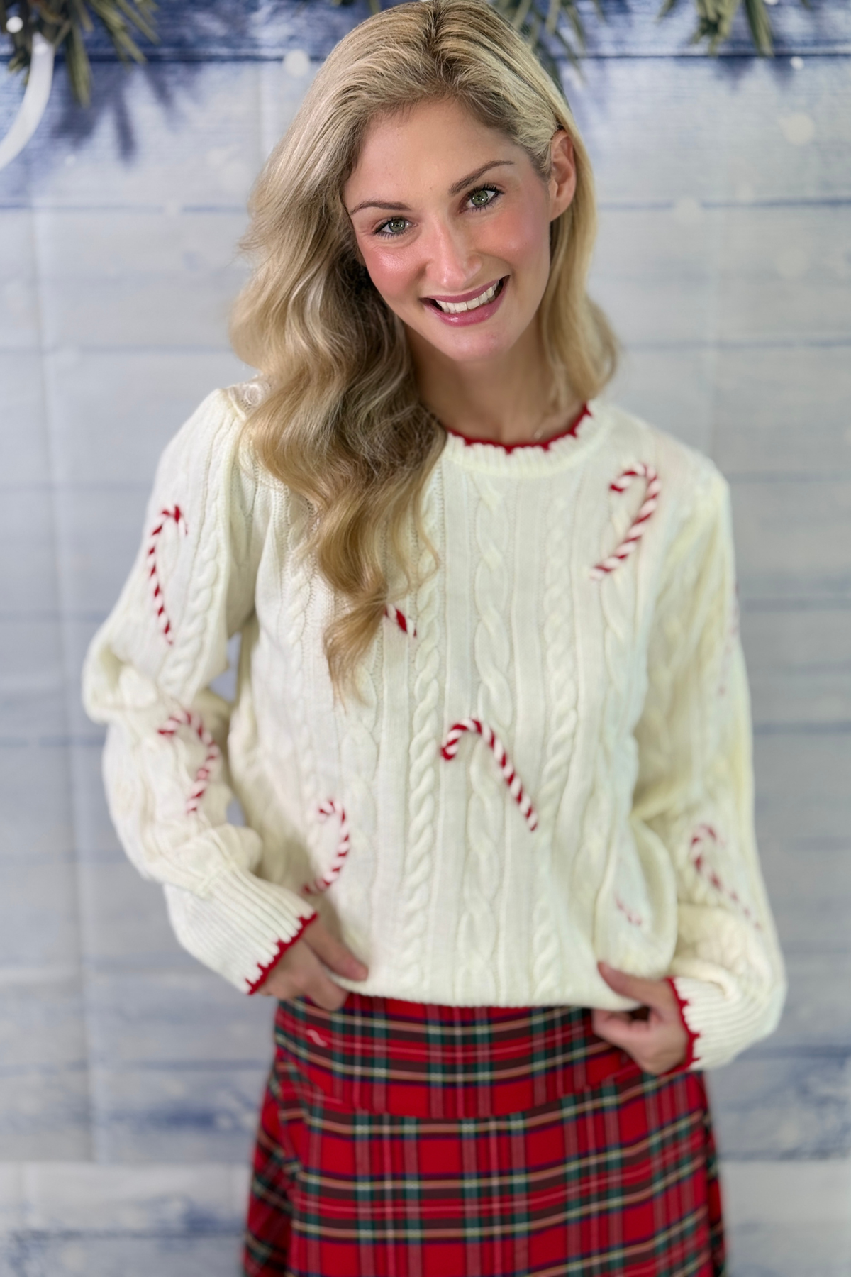 Women’s ivory Christmas sweater with candy cane details