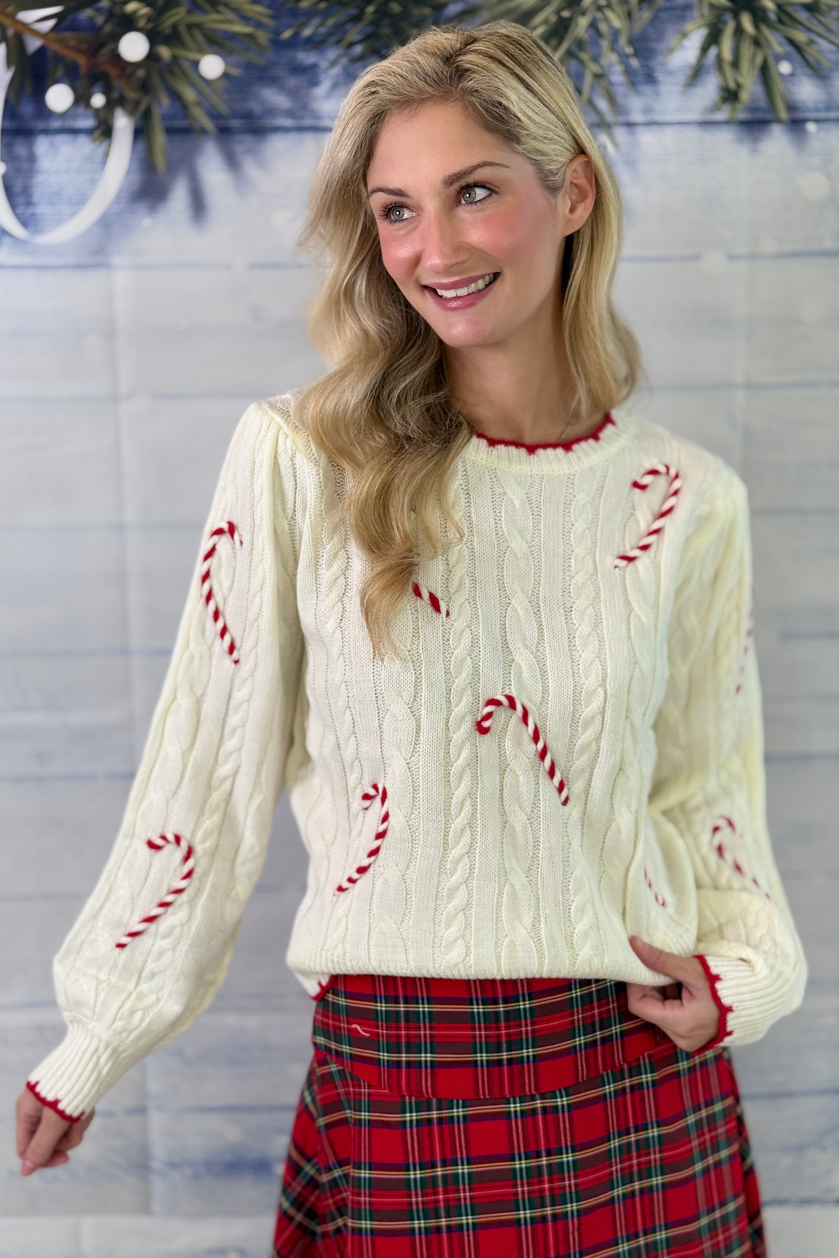 Cable knit holiday sweater with red candy canes