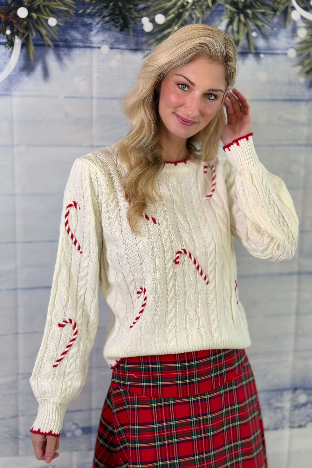 Ivory and red boutique Christmas sweater
Candy cane sweater styled with red plaid midi skirt
