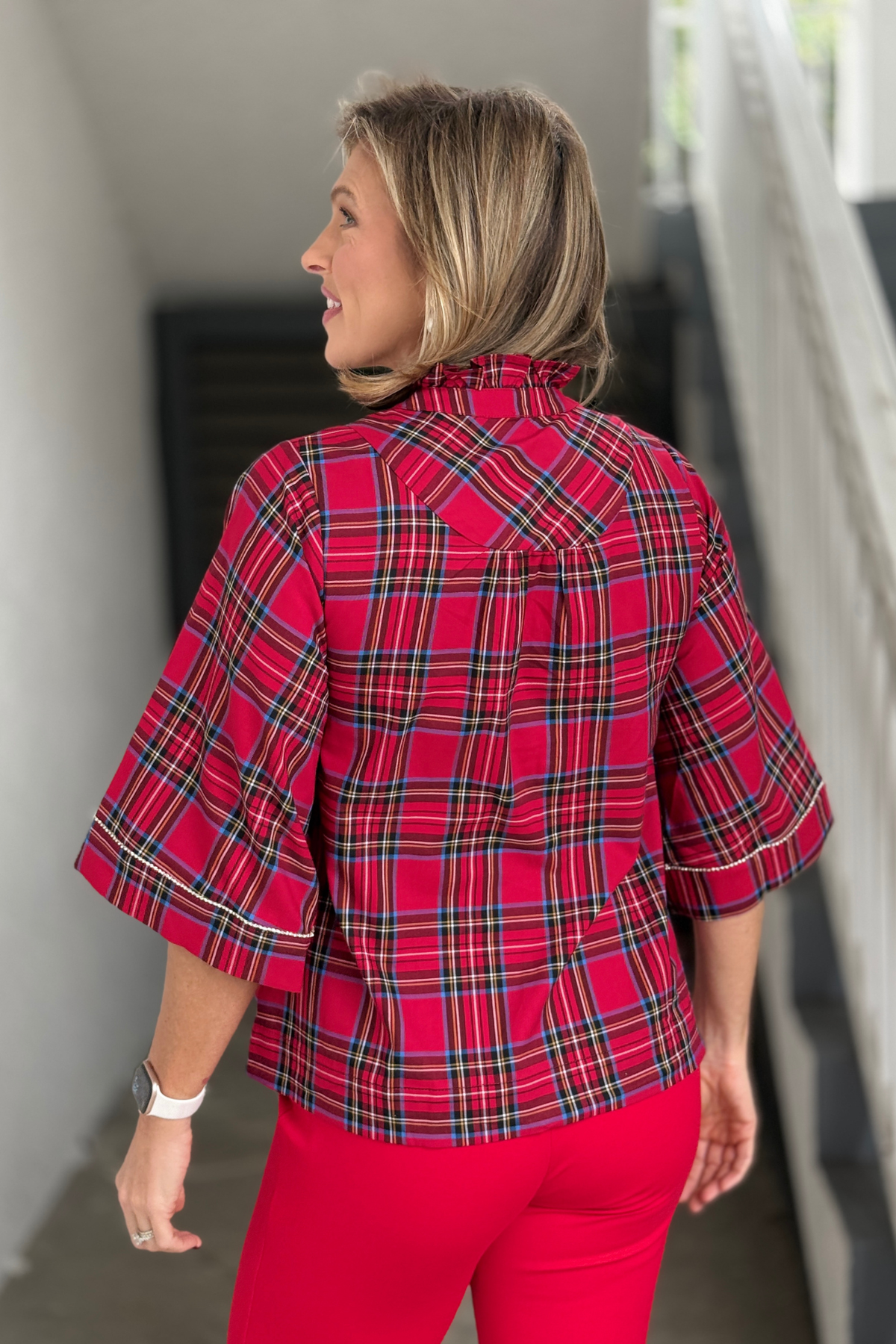 Back view of red plaid ruffle neck Christmas blouse