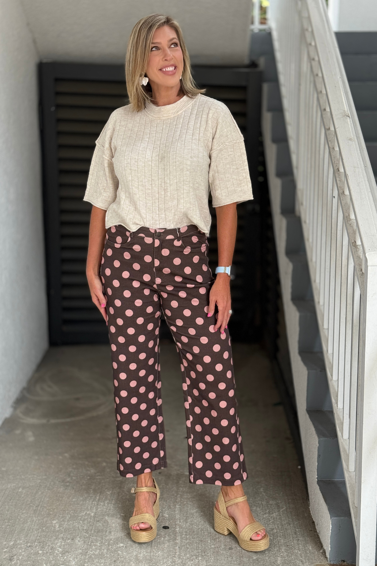 Woman wearing mocha and pink polka dot wide leg pants