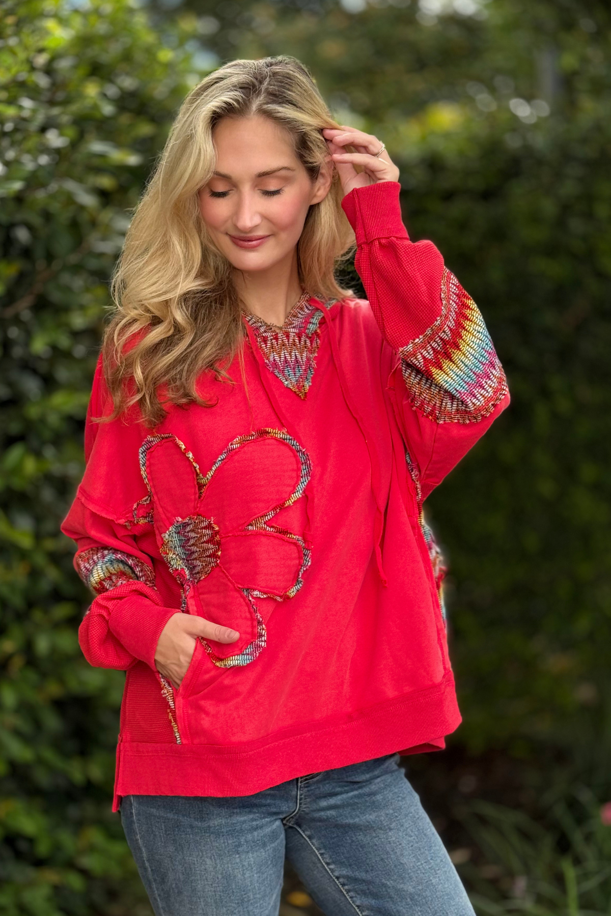 Model wearing red mineral wash oversized hoodie with daisy patch design – Daisy Patch Hoodie