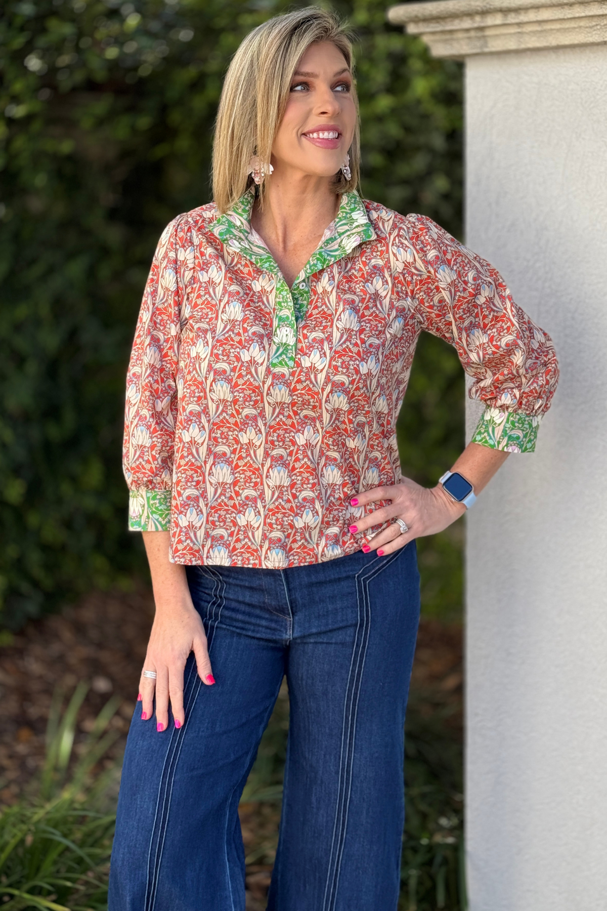 Orange floral blouse with green contrast collar and cuffs