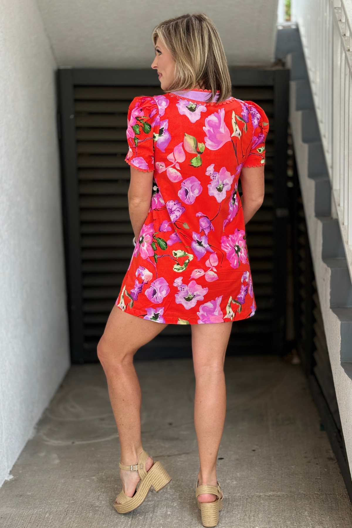 Bright red floral dress with scalloped trim and side pockets