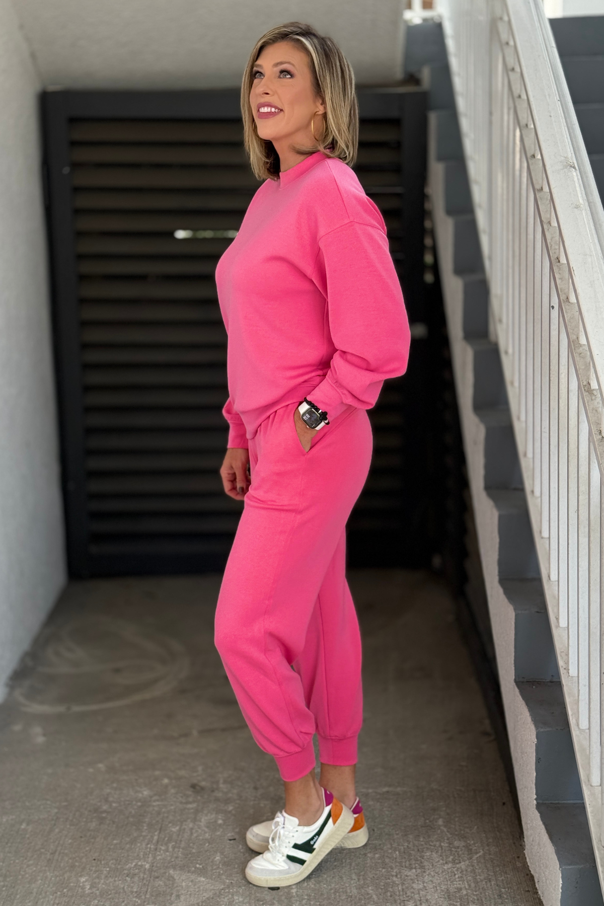 Bright pink women’s travel outfit with mock neck pullover and joggers