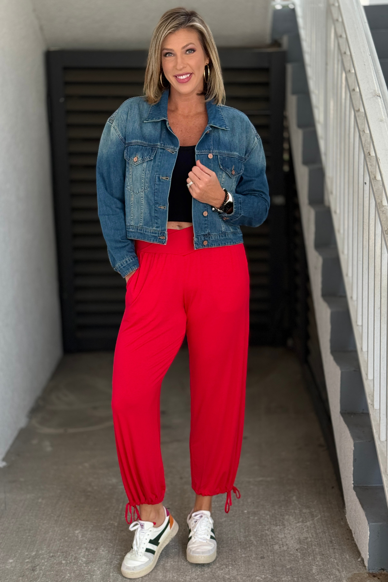 Cherry red V-waist modal pants styled with black tank and denim jacket