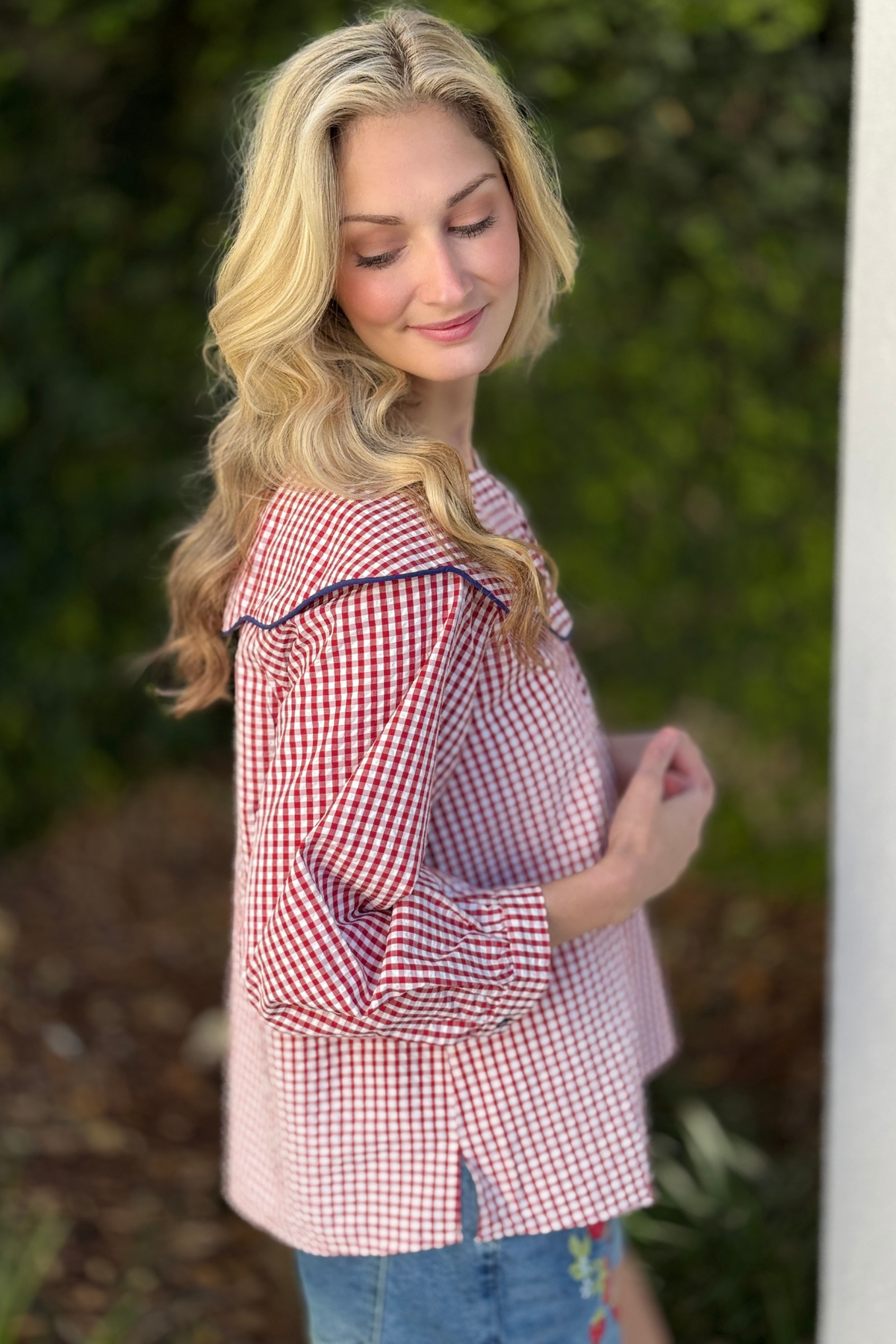 Red gingham blouse styled with embroidered denim shorts