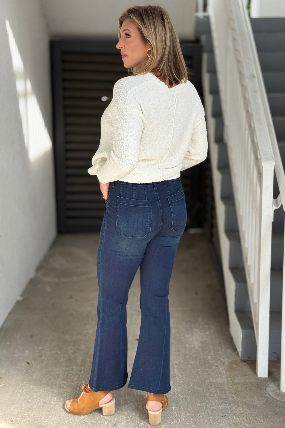 Renuar dark denim flare jeans styled with an ivory sweater