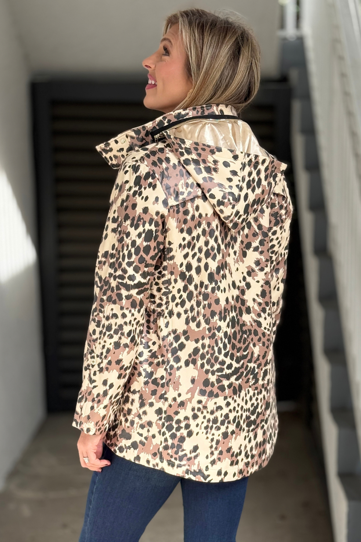 Back view of women’s Renuar leopard raincoat with hood