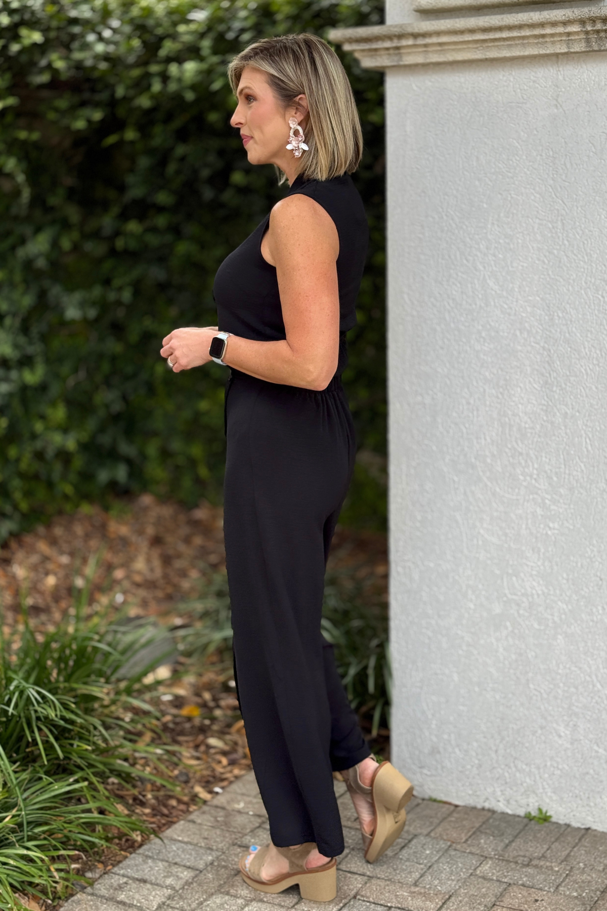 Flowy black palazzo pants styled with sleeveless top