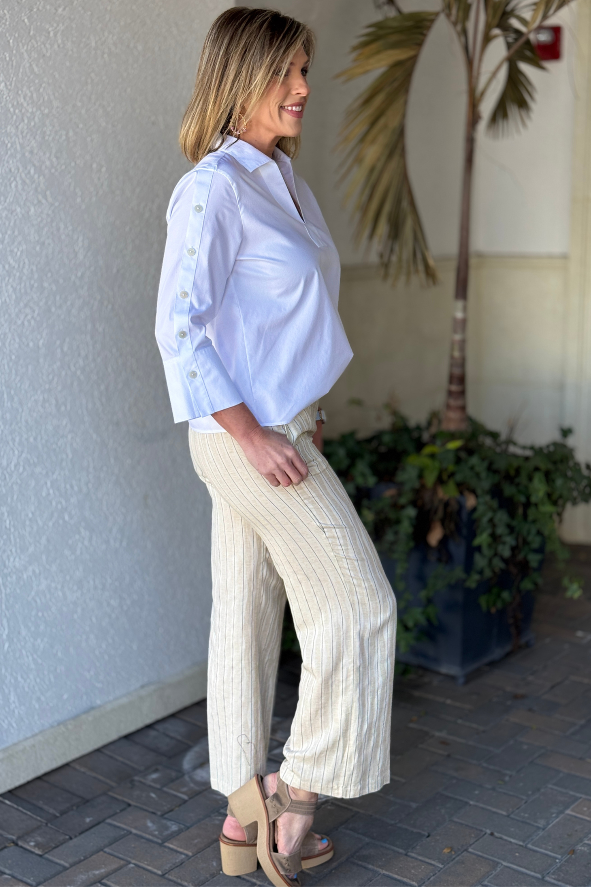 Spring 2026 neutral striped women’s trousers styled with white blouse