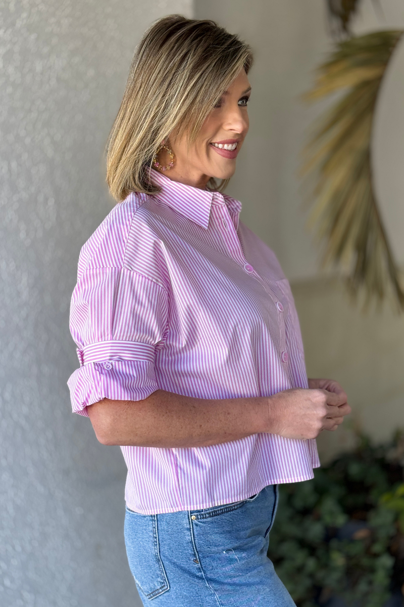 Side view of pink striped blouse with rolled sleeves