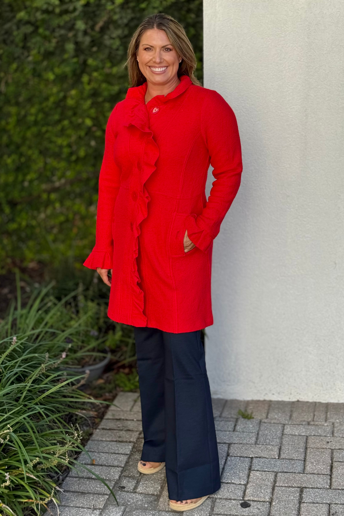 Front view of The Scarlett Ruffle Button Jacket in red with ruffle placket and button closure