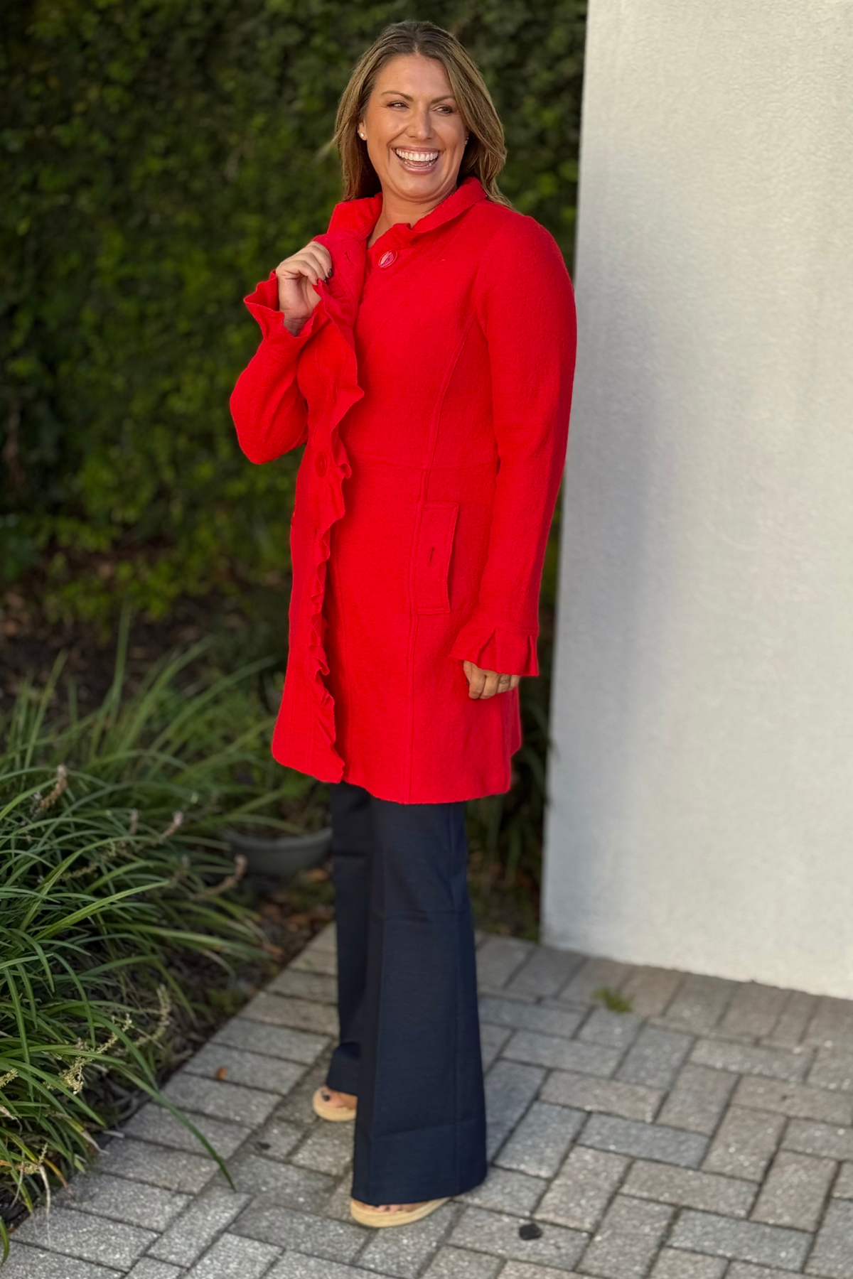 Side angle of model wearing The Scarlett Ruffle Button Jacket showing flounce sleeve detail