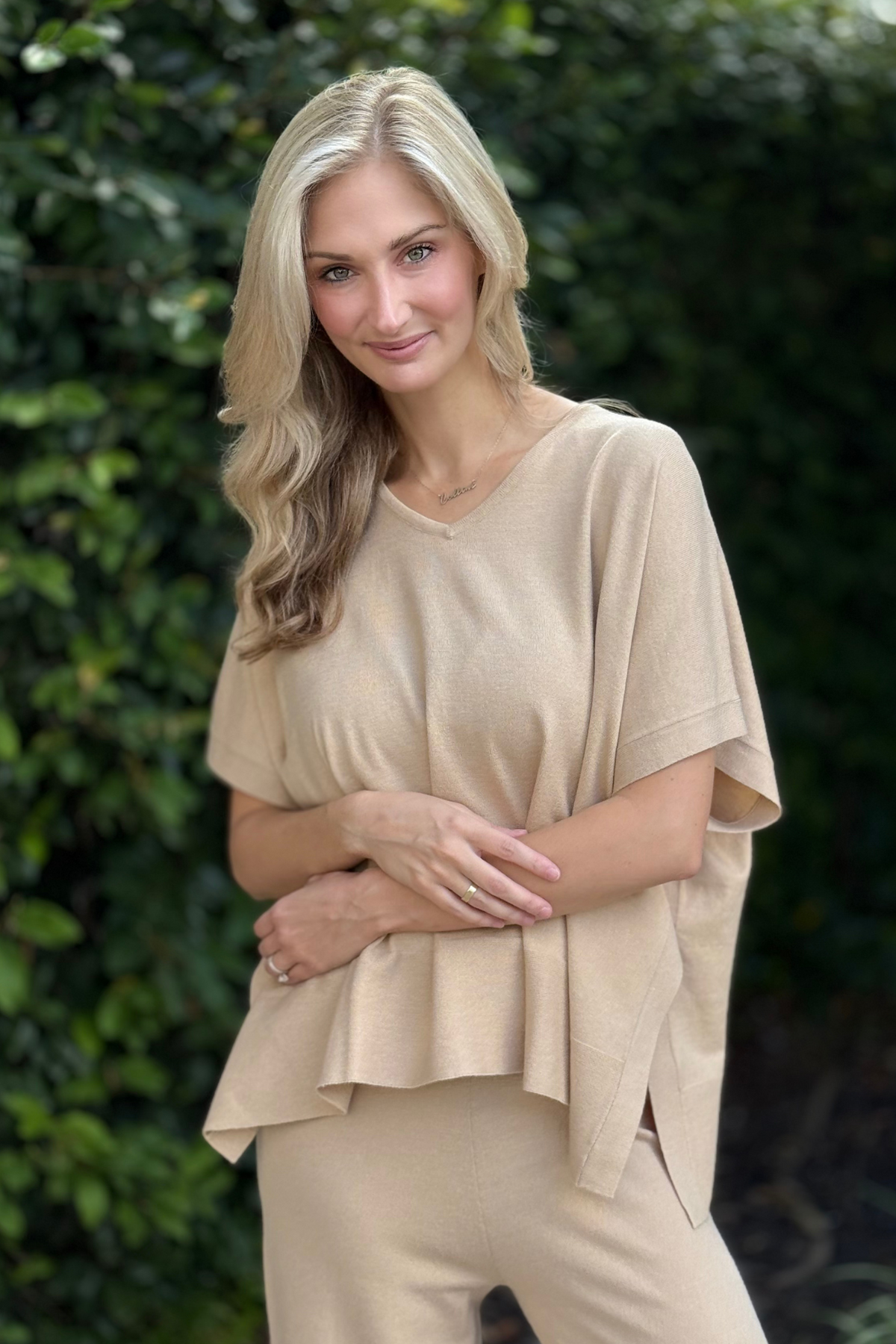 Front view of model wearing Renuar Knit V-Neck Poncho Top in Tan