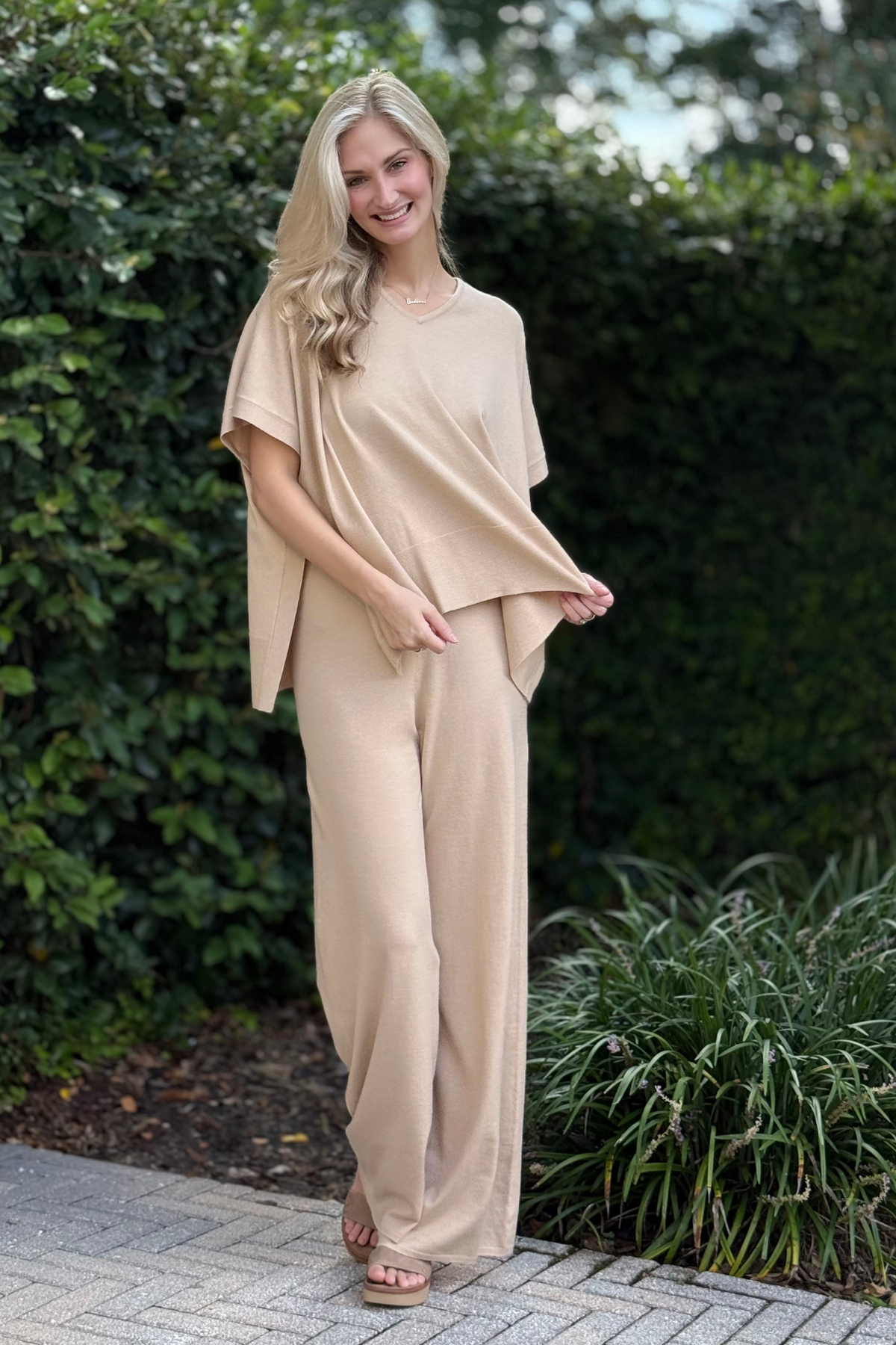 Side view of tan knit flare pants showing flattering bootcut silhouette