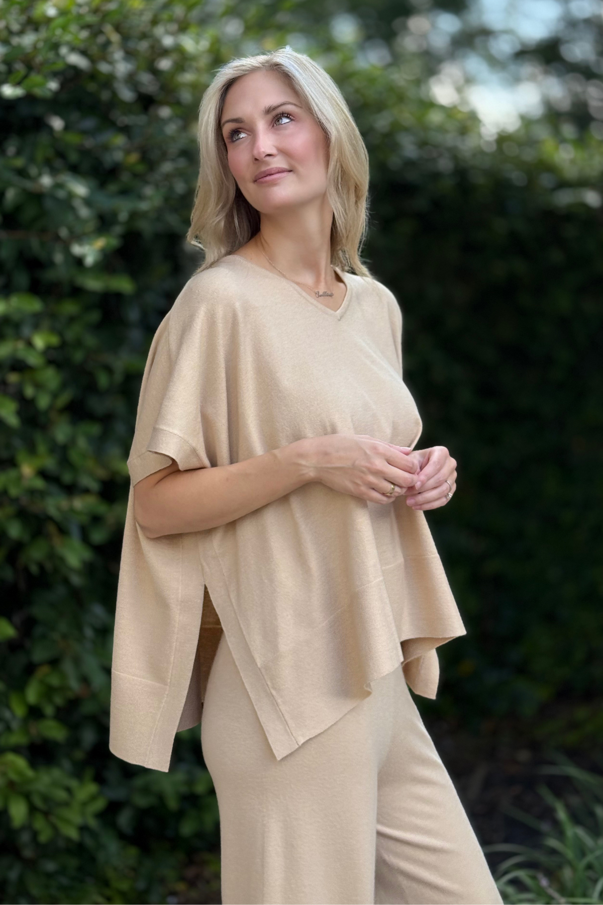 Close-up of soft knit fabric and V-neckline of the Renuar Poncho Top