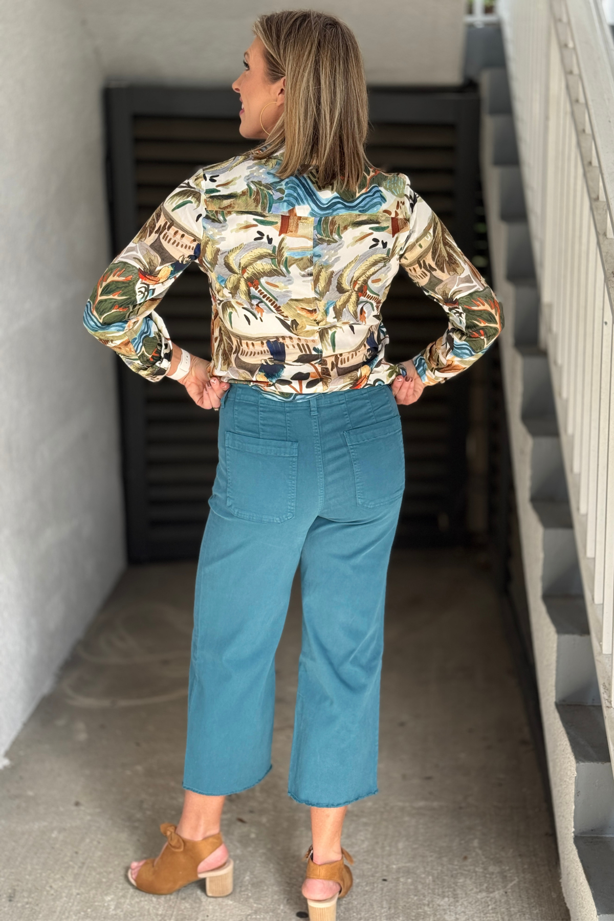 Teal cropped pants with fringe hem detail by Renuar