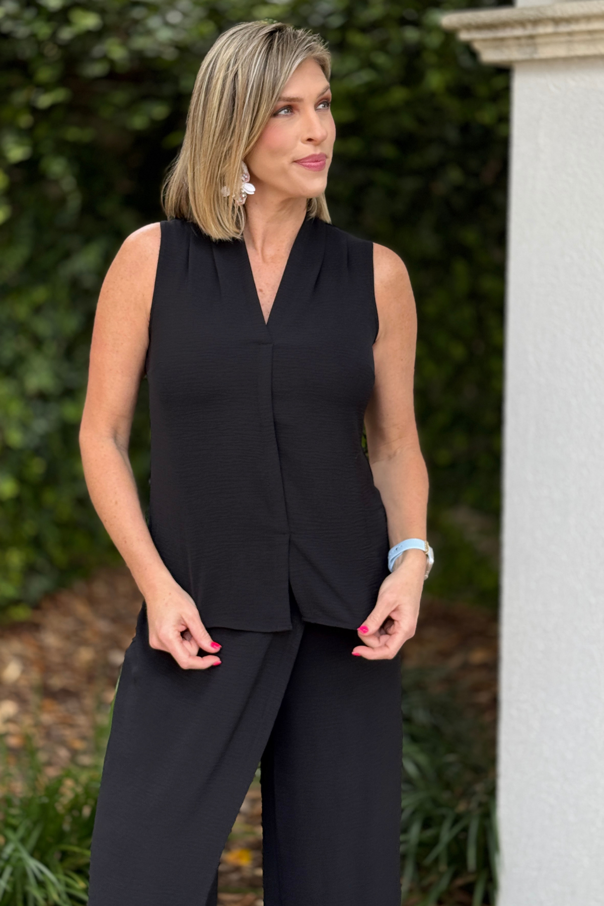 Black sleeveless women’s blouse with straight cut silhouette