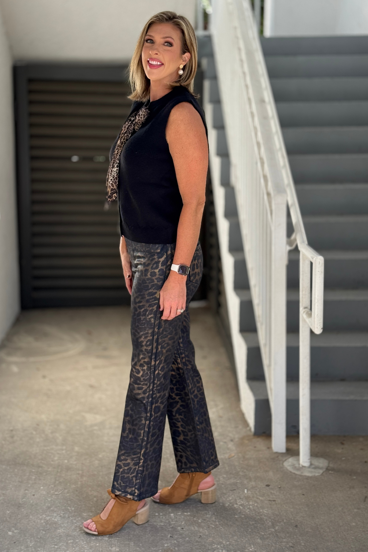 Renuar stretch leopard denim pants styled with black knit vest