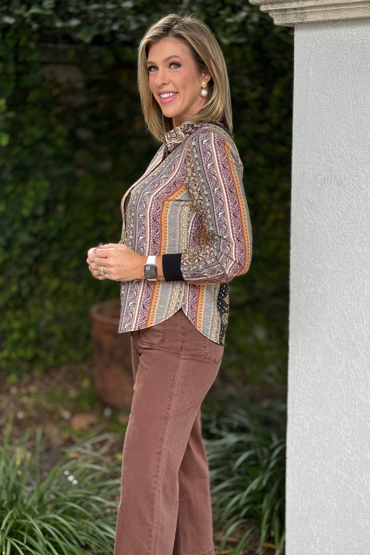 Paisley stripe button down blouse styled with chocolate pants