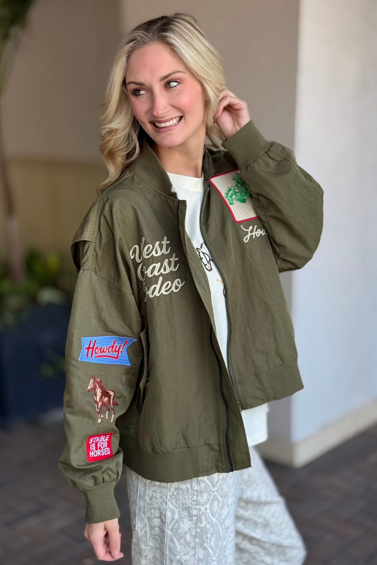 Close-up of western patches and embroidery on The Rodeo Rambler Bomber