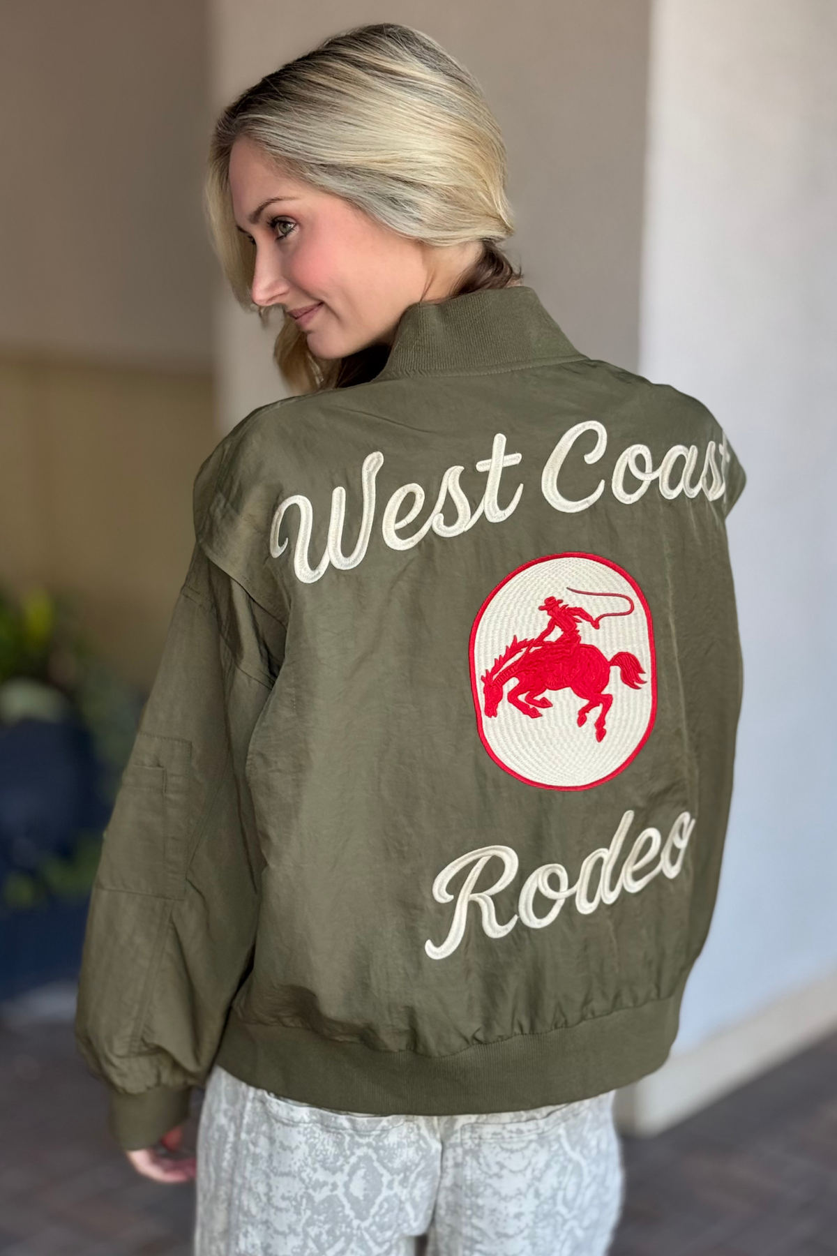 Back view of western-inspired embroidered bomber jacket in olive green