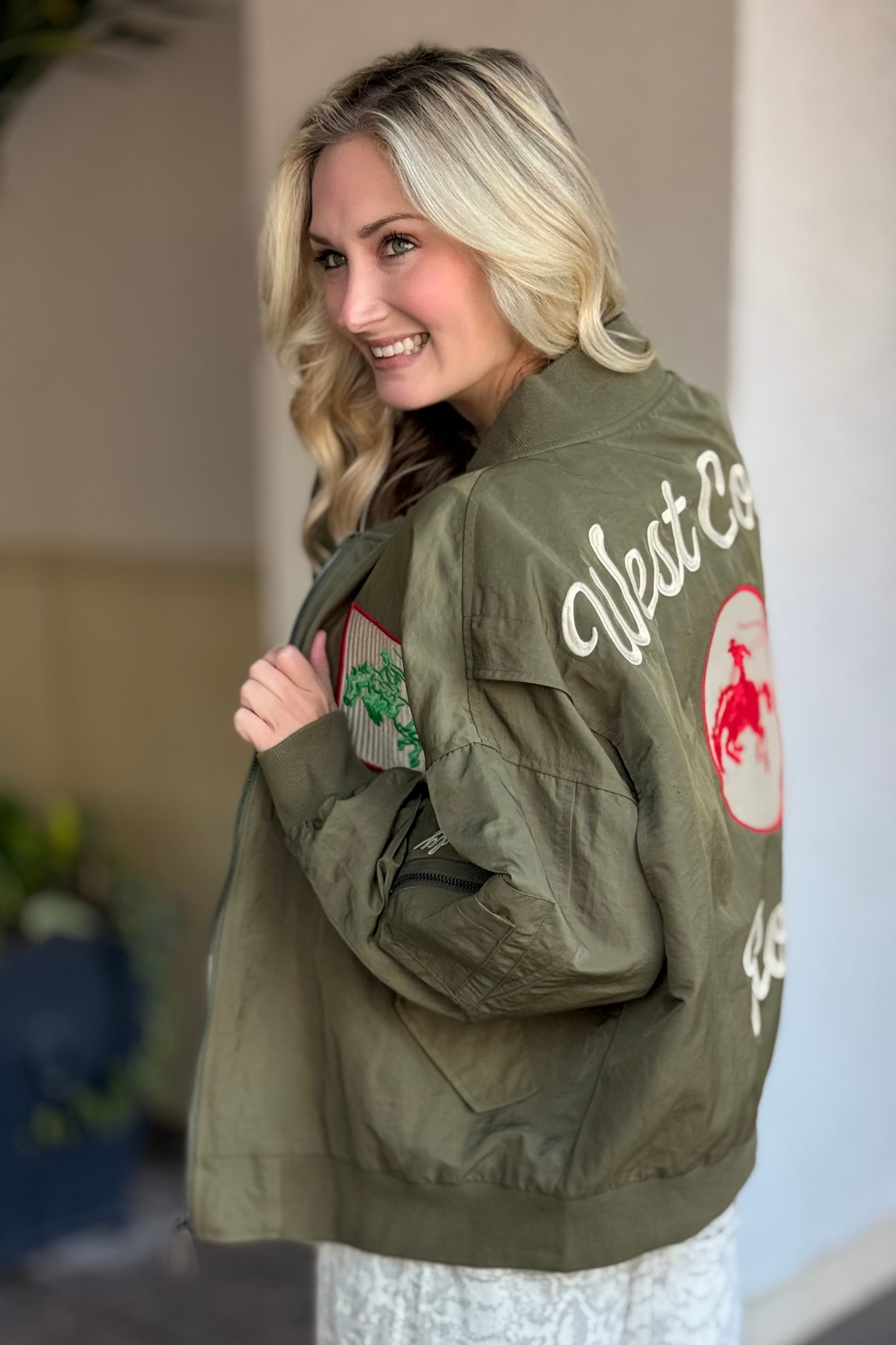 Flat lay of The Rodeo Rambler Embroidered Bomber showing front zipper and details