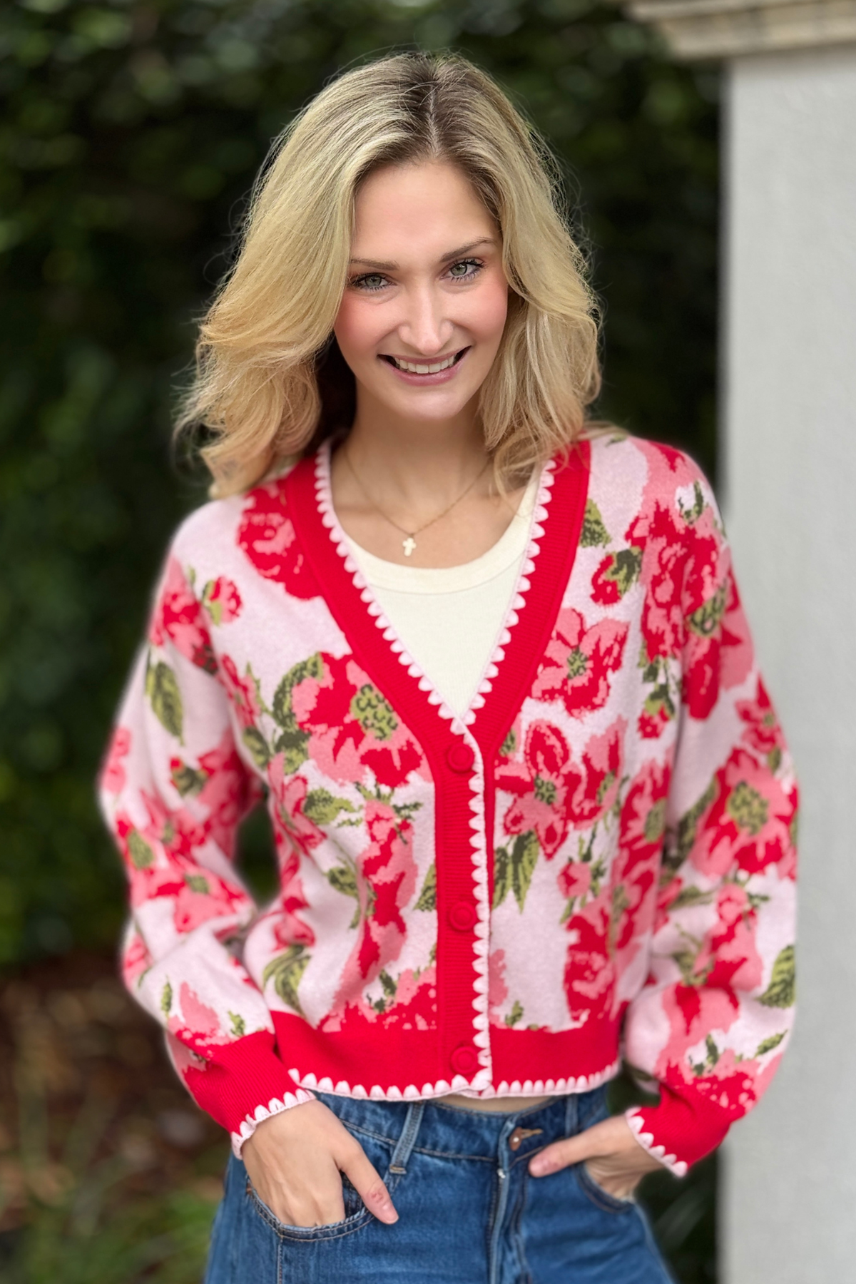 Side view of floral intarsia cardigan styled with denim shorts