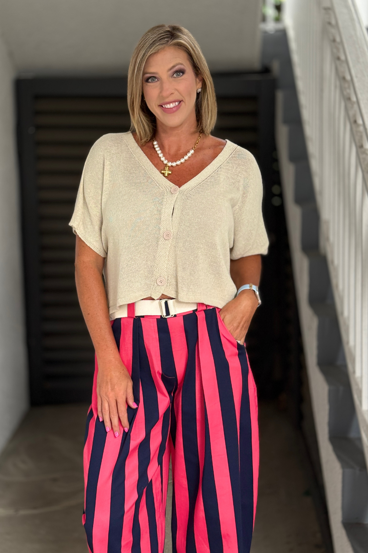 Lightweight natural knit cardigan styled with striped pants