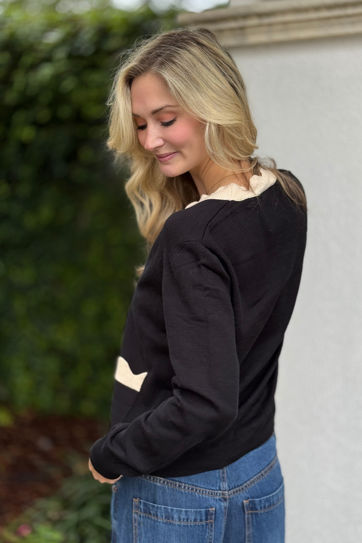 Women wearing black and cream knit cardigan
