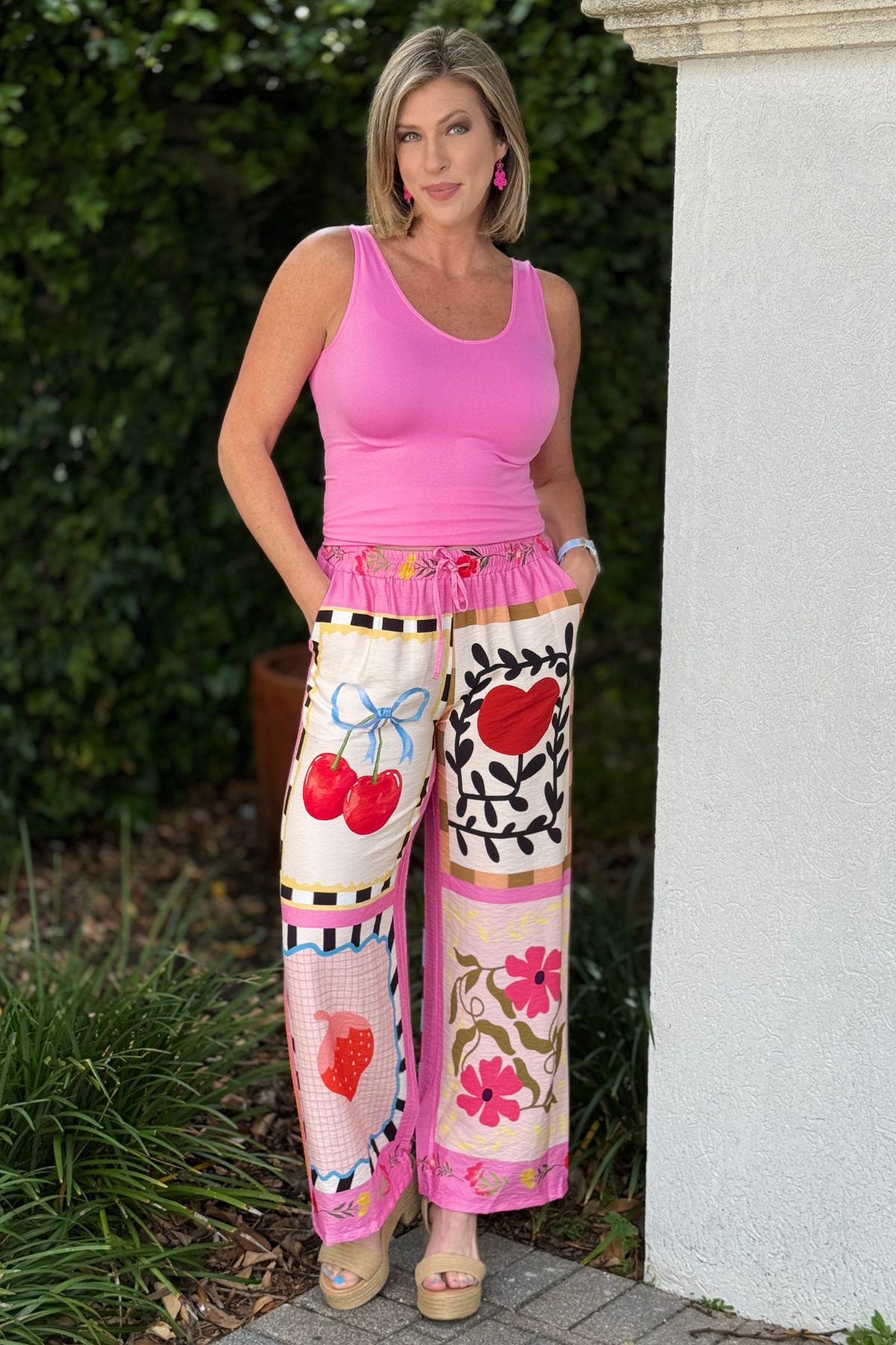 Back view of vibrant Italian patchwork pants with fruit and dove graphics