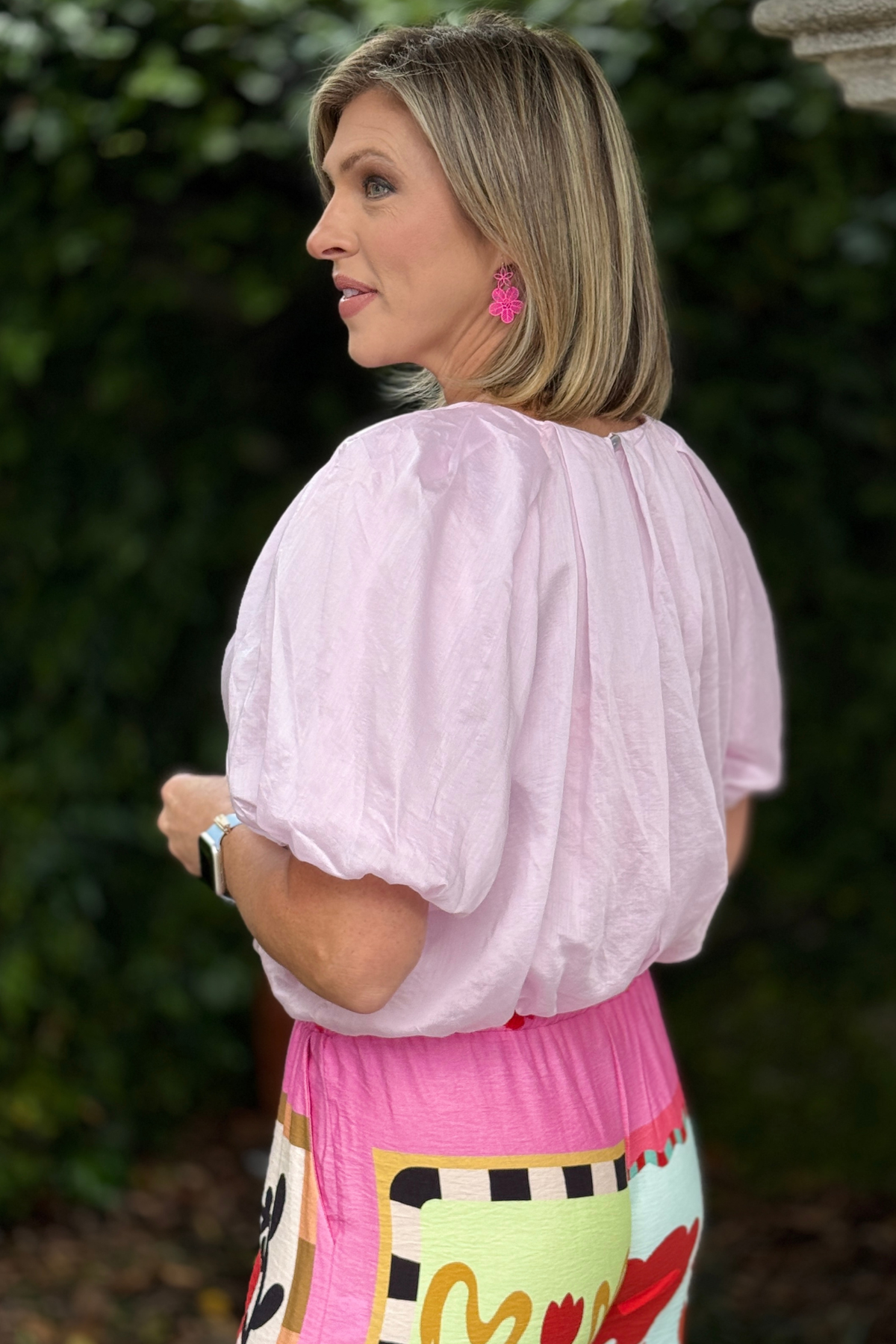 Back view of pink silk blouse with bubble hem