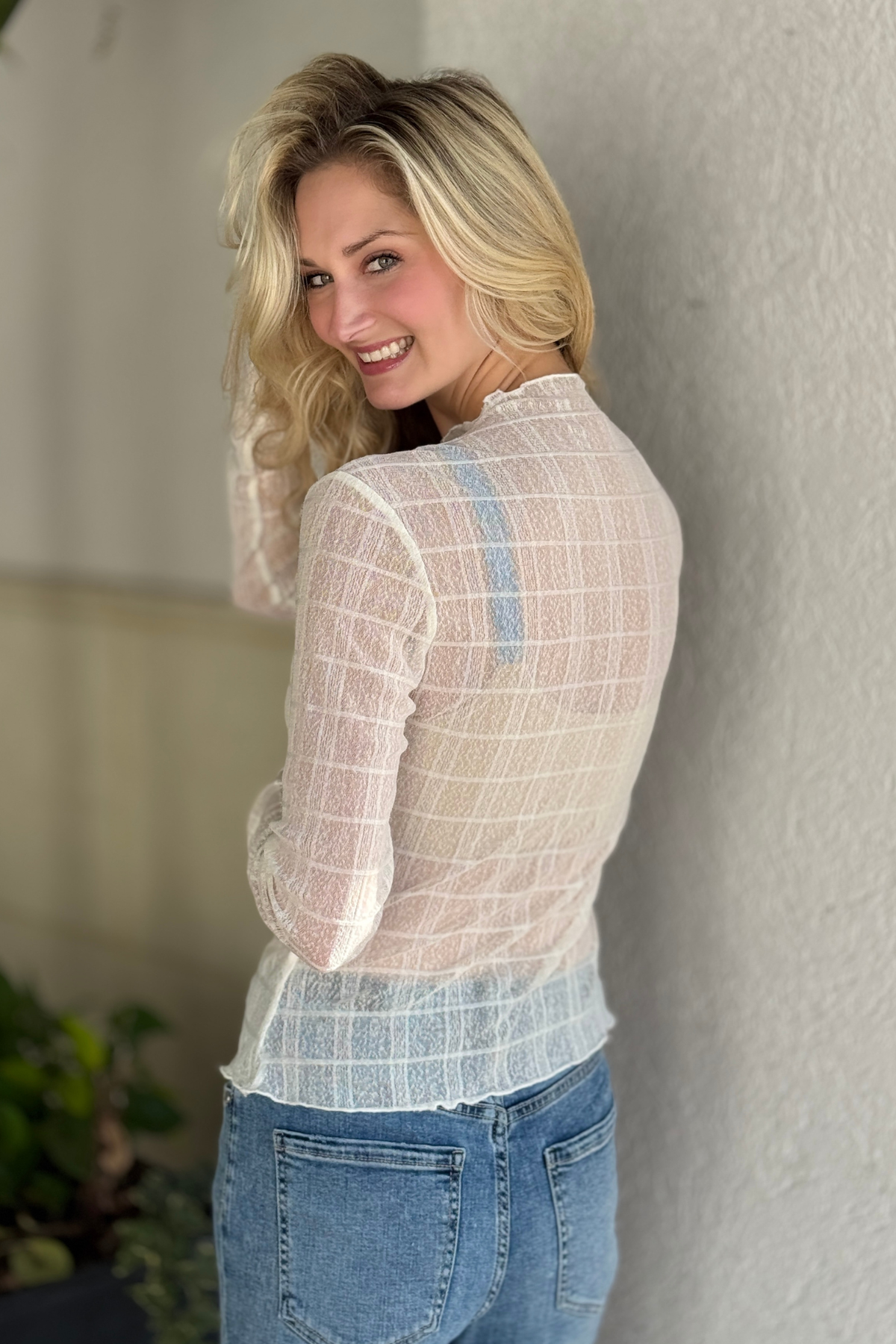 Close-up of sheer plaid mesh fabric and lettuce trim detail