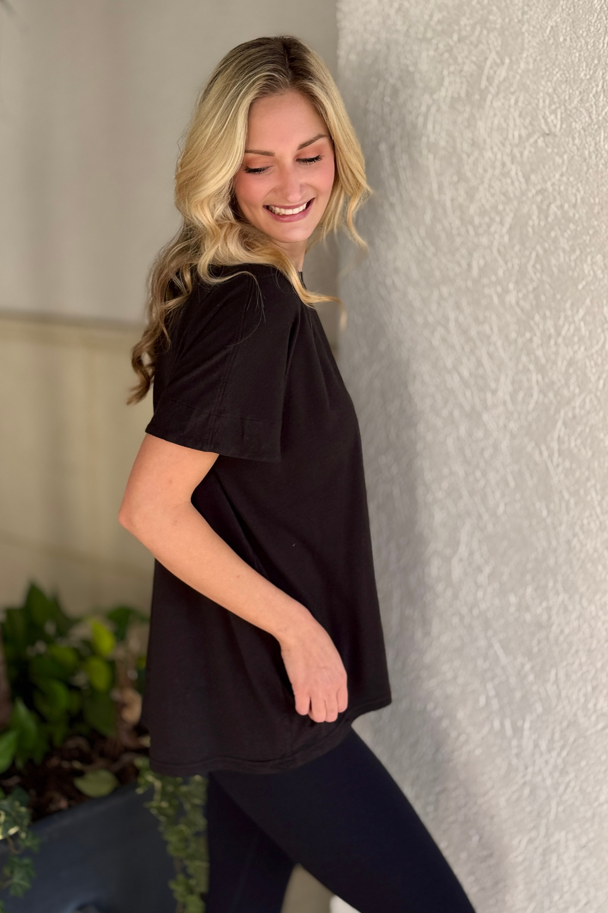 Oversized black tee with cap sleeves and back pleat