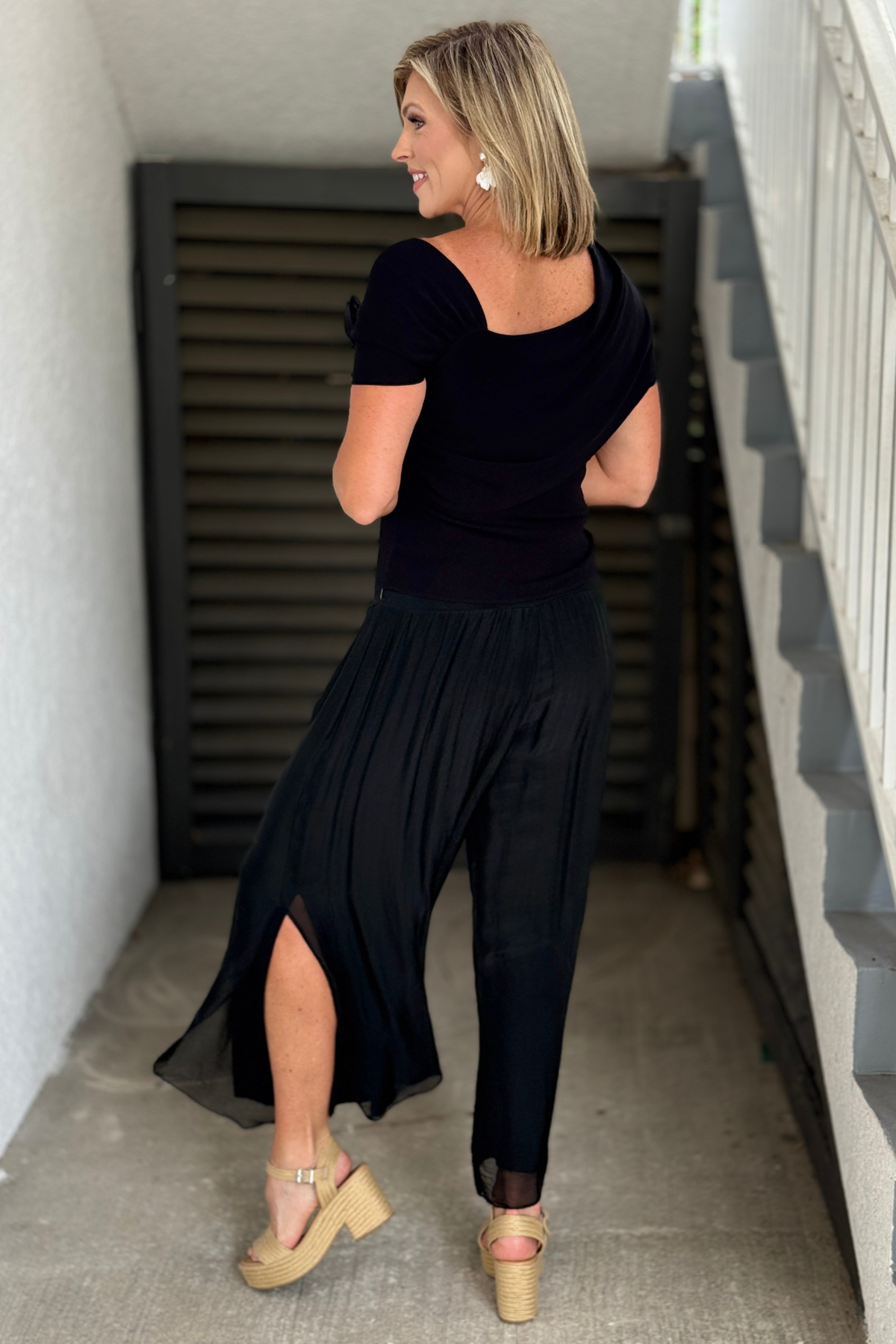 Back view of black silk side slit boutique pants