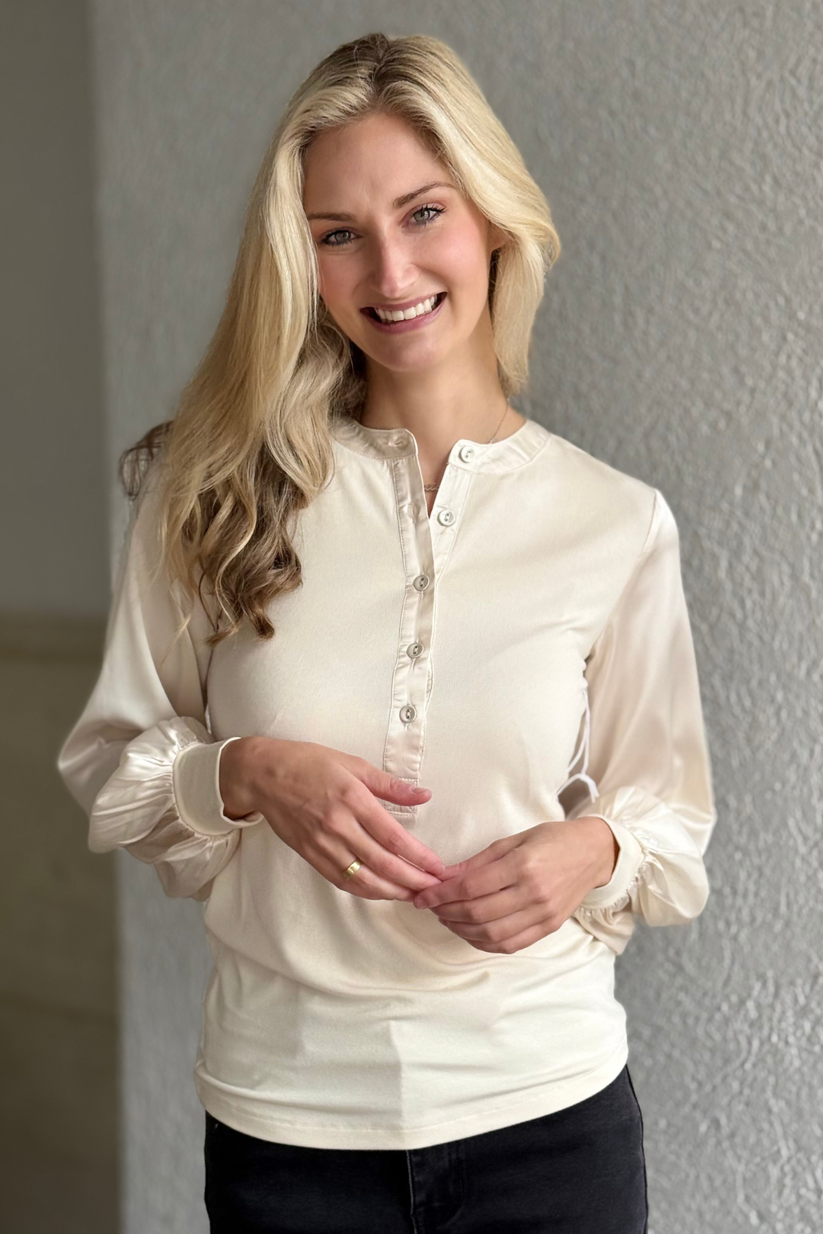 Model wearing the Janie Satin Sleeve Top in Pearl by Six Fifty — cream long-sleeve blouse with ribbed knit body and satin sleeves.