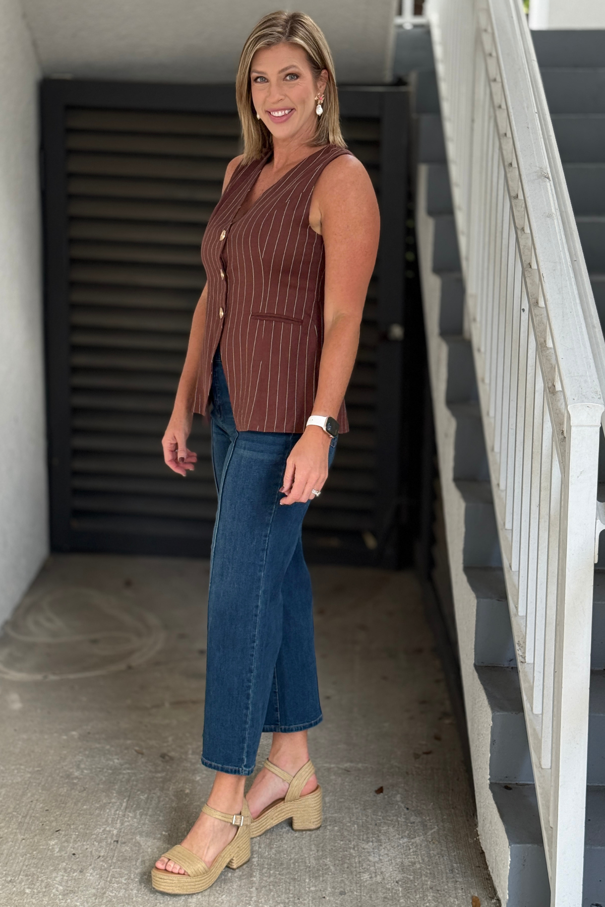 Brown tailored V-neck vest styled with denim