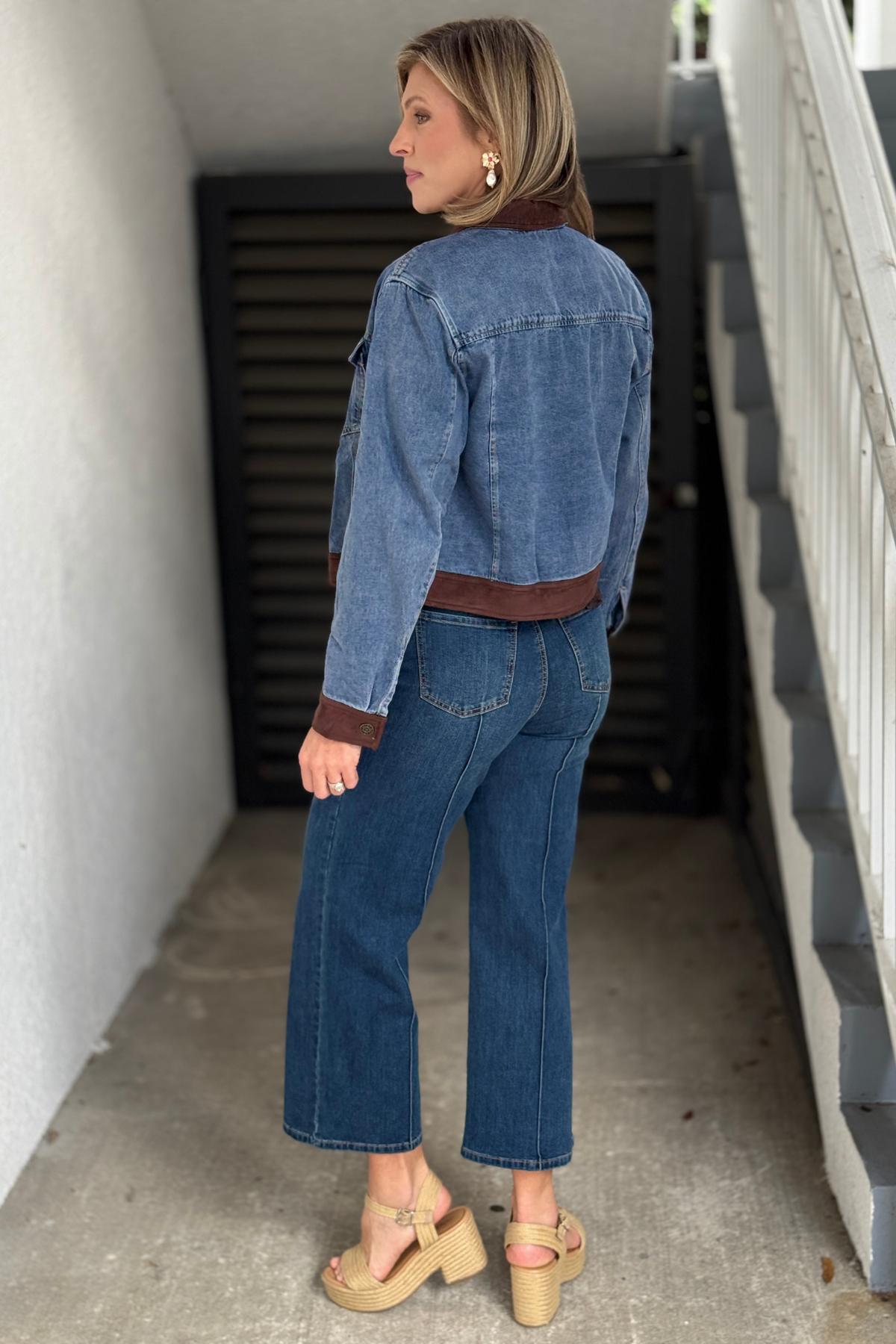 Medium wash jean jacket with chest flap pockets and suede accents