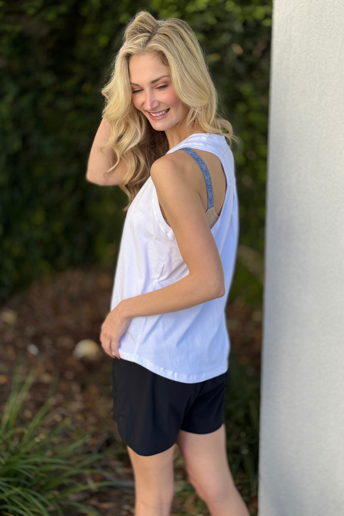White relaxed racer tank styled with black athletic shorts