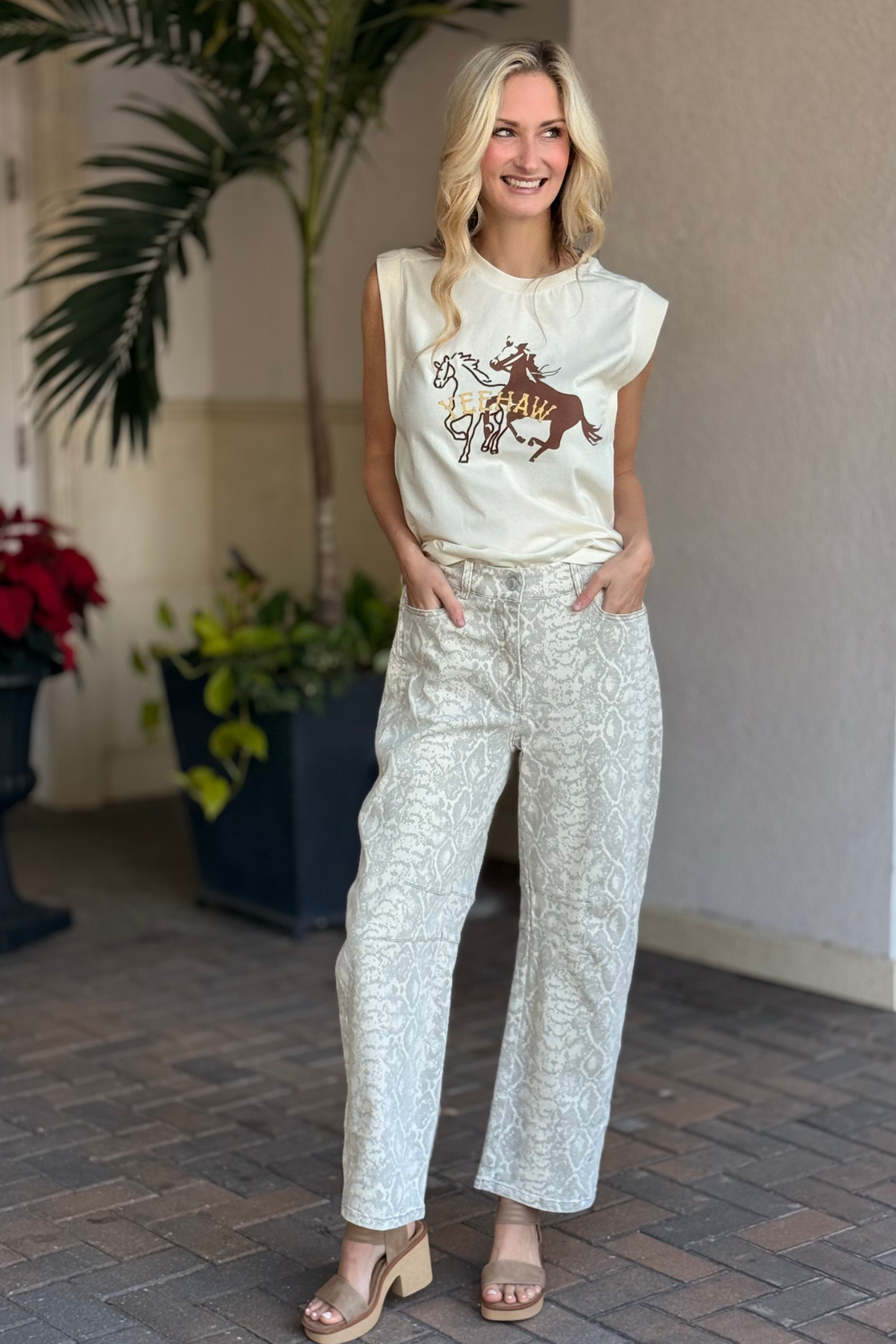 Close-up front view of snake print high-waist barrel twill pants