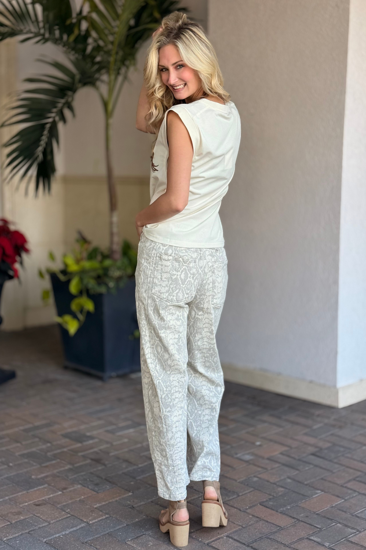 Model styling snake print pants with graphic Yeehaw tank