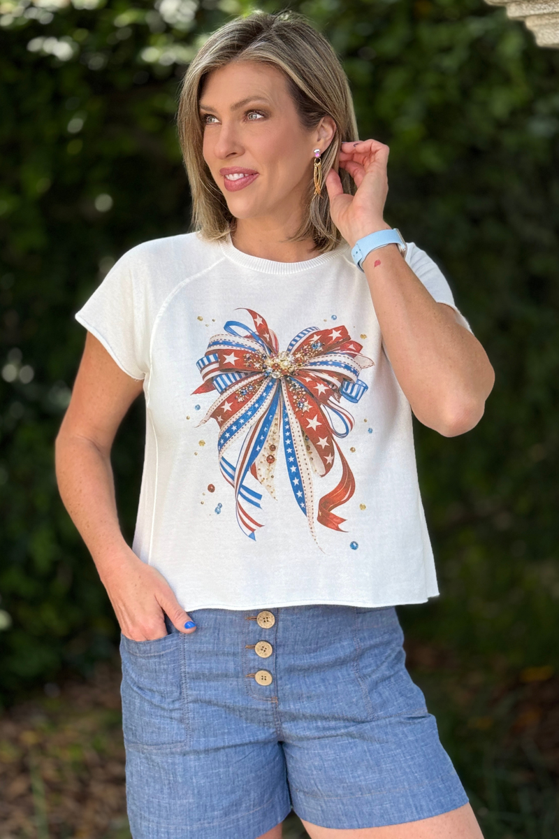 stars and stripes bow shirt flat lay with denim and sneakers
