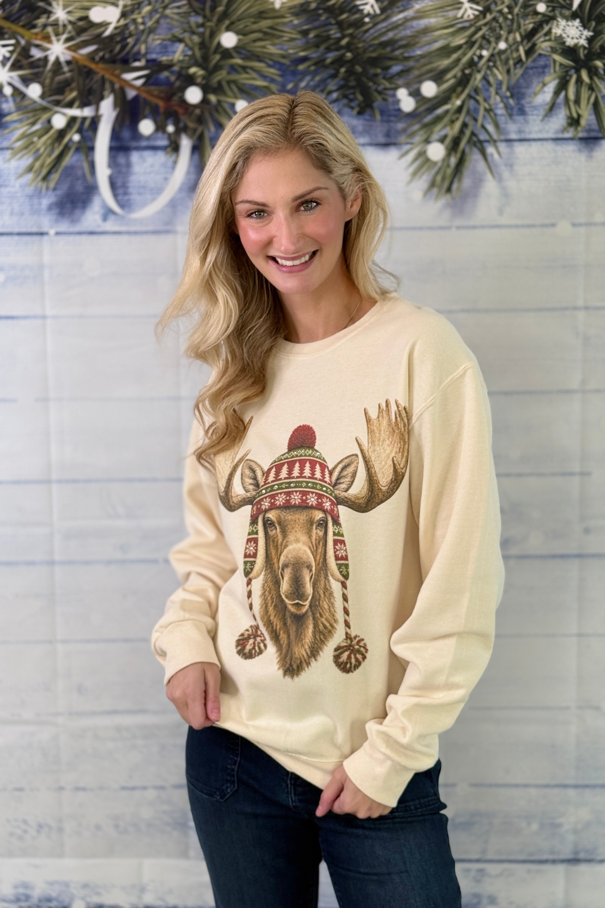 Cream holiday sweatshirt with moose wearing Fair Isle winter hat  