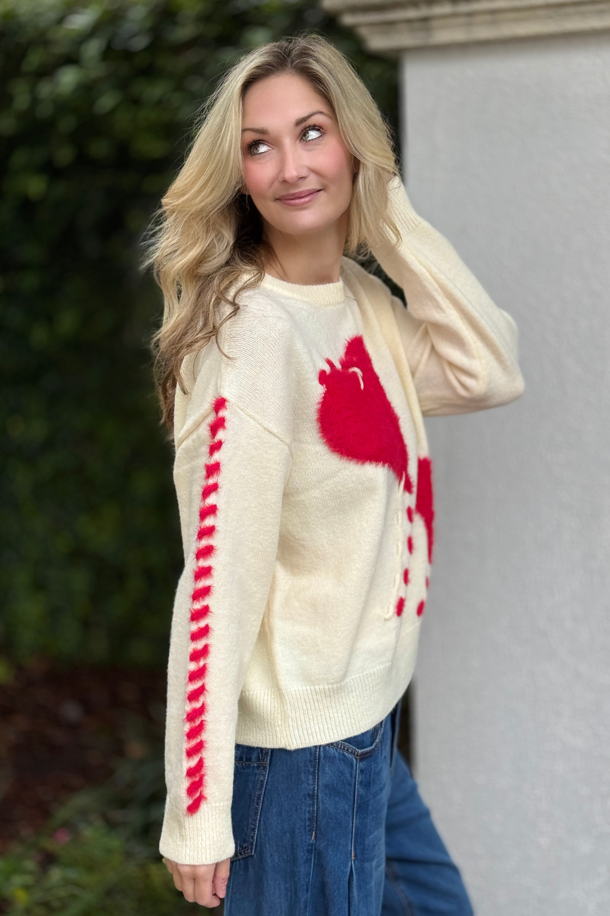 Close-up of fuzzy red heart knit sweater with contrast stitching