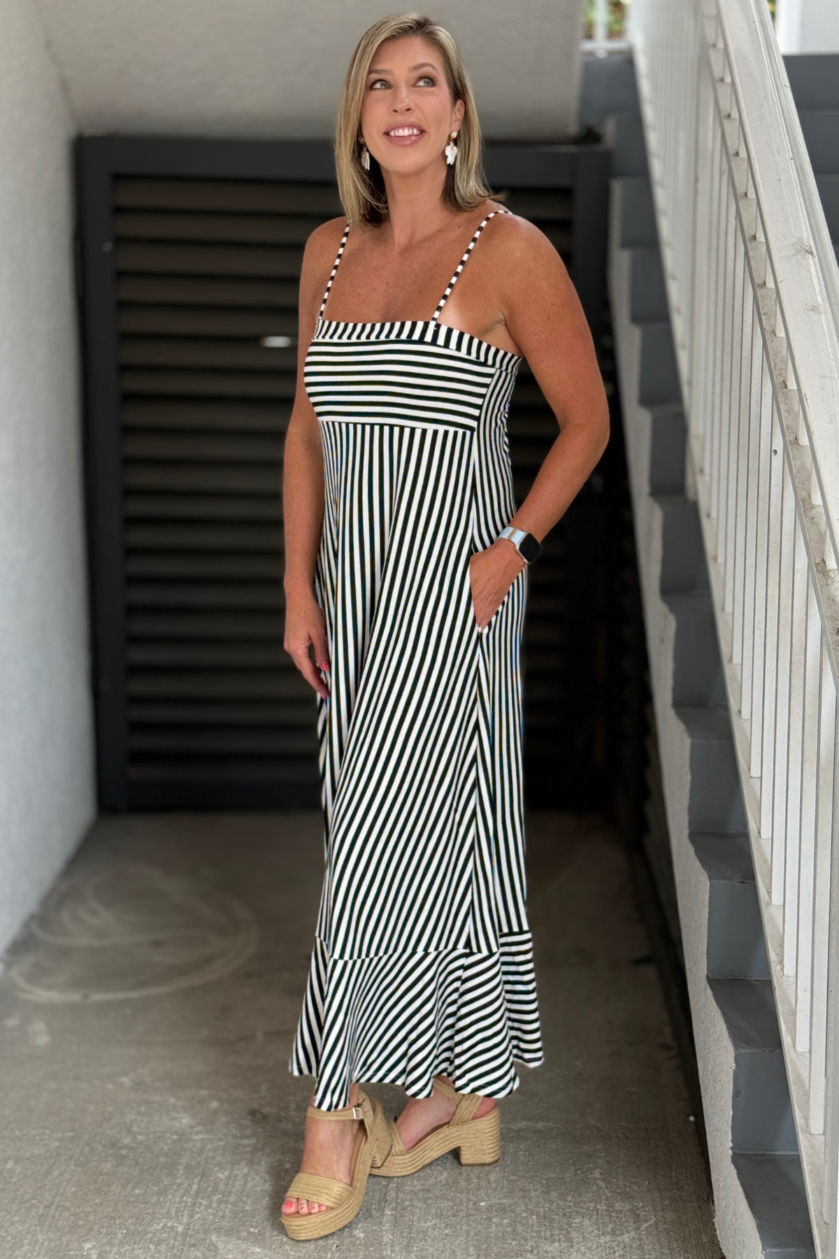 Side view of black and white stripe maxi dress